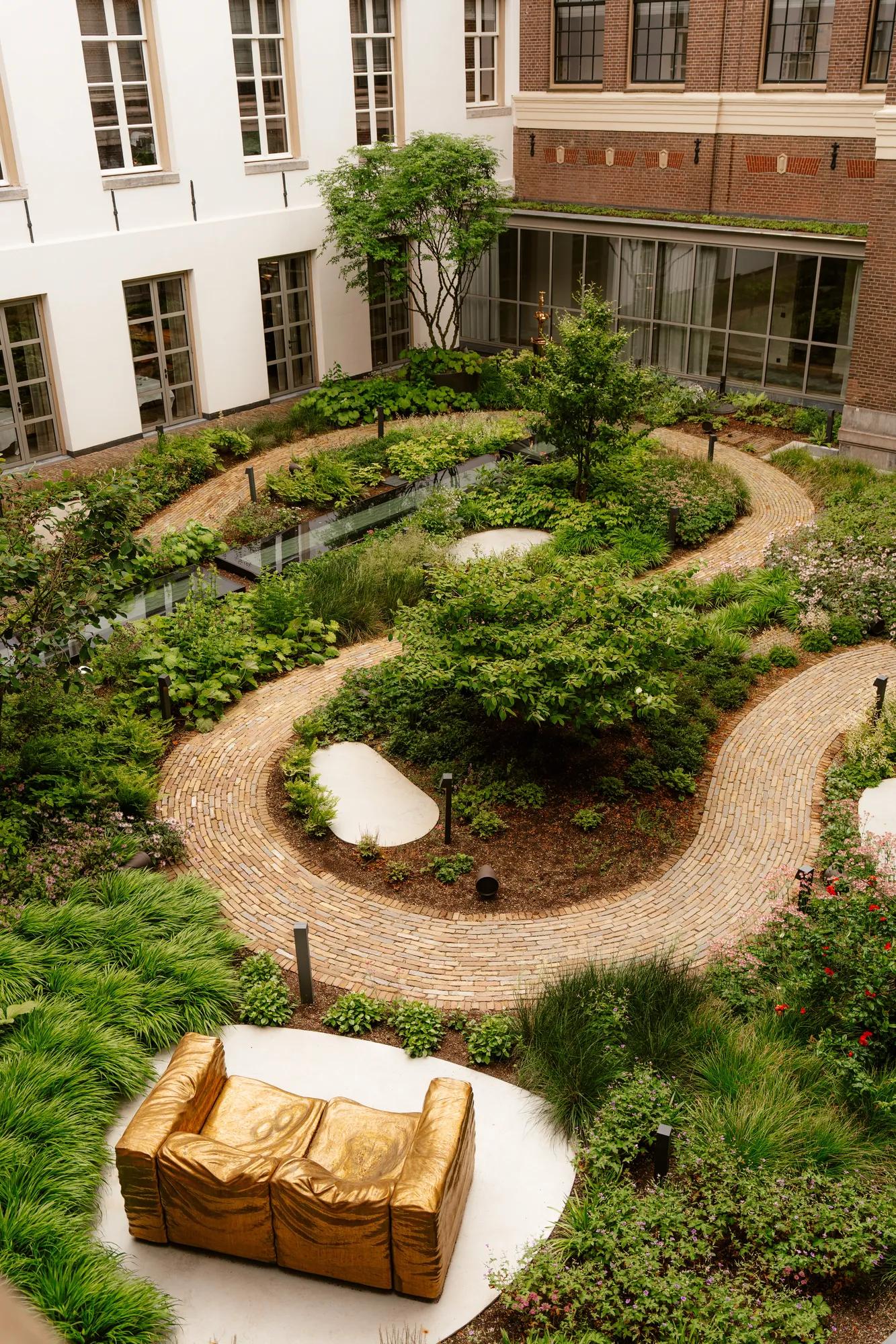 Rosewood Amsterdam: De Tuin, the courtyard garden by Piet Oudolf, with curving brick paths and planting
