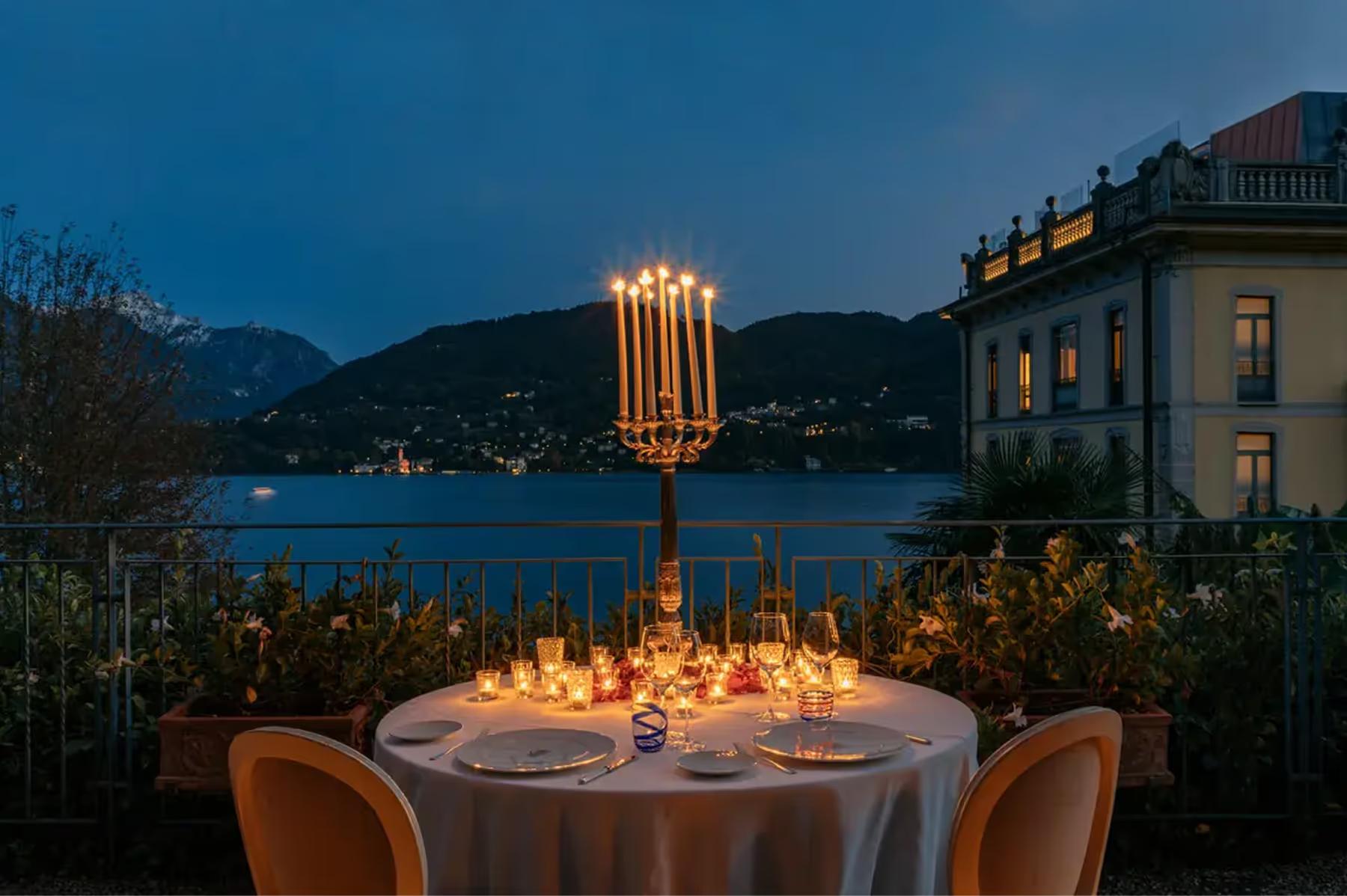 Grand Hotel Tremezzo: elegant outdoor dinner table at dusk with lakeside light and mountains