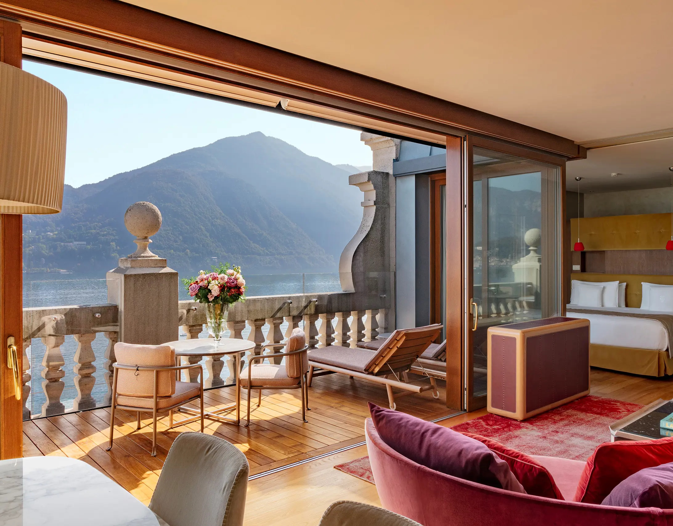 Grand Hotel Tremezzo: suite sitting area with mountain-lake terrace and burgundy lounge seating