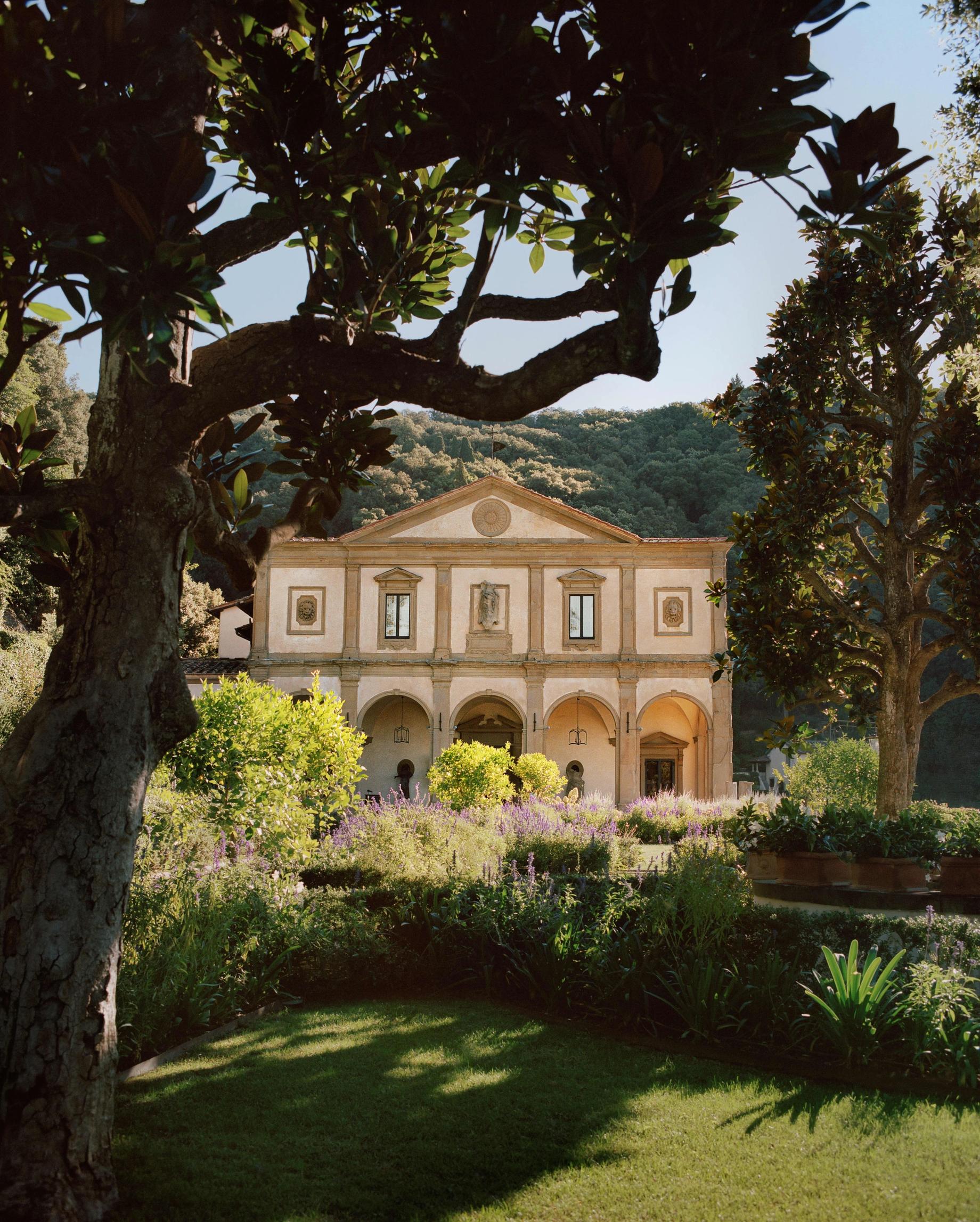 A Renaissance villa framed by trees above Florence