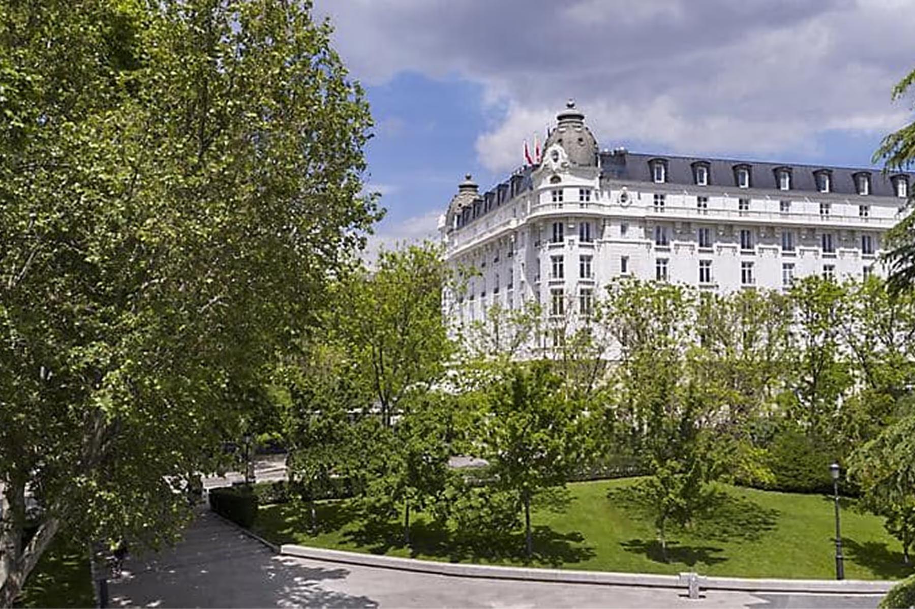 Mandarin Oriental Ritz, Madrid: palatial facade viewed from tree-lined gardens in daylight