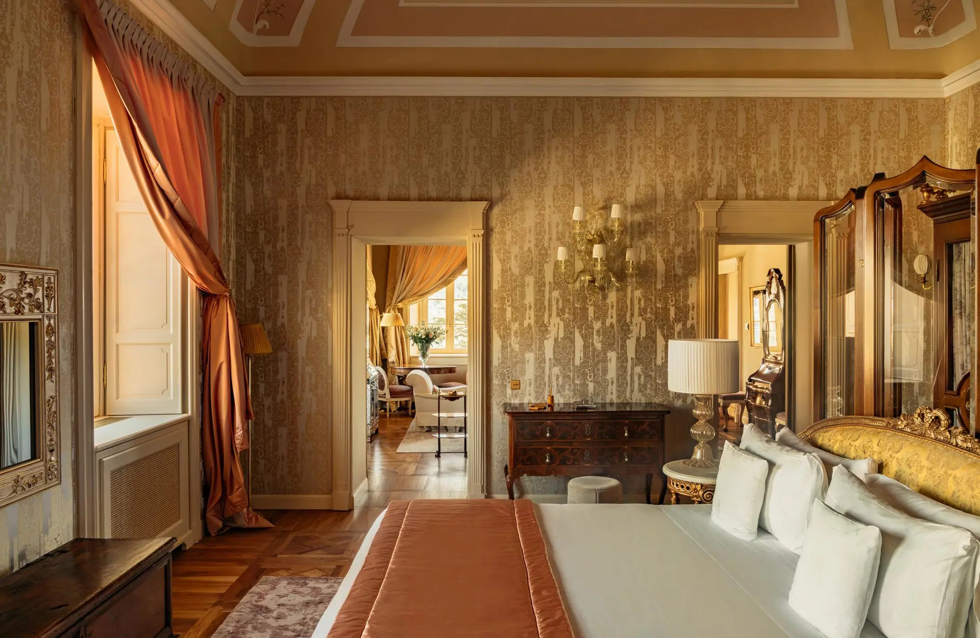 An entry hallway with geometric ceiling, red curtain, and white marble fireplace