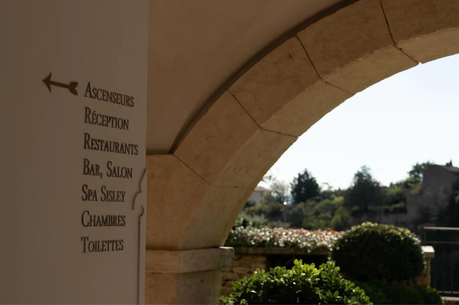 Stone facade with arched opening and outdoor terrace