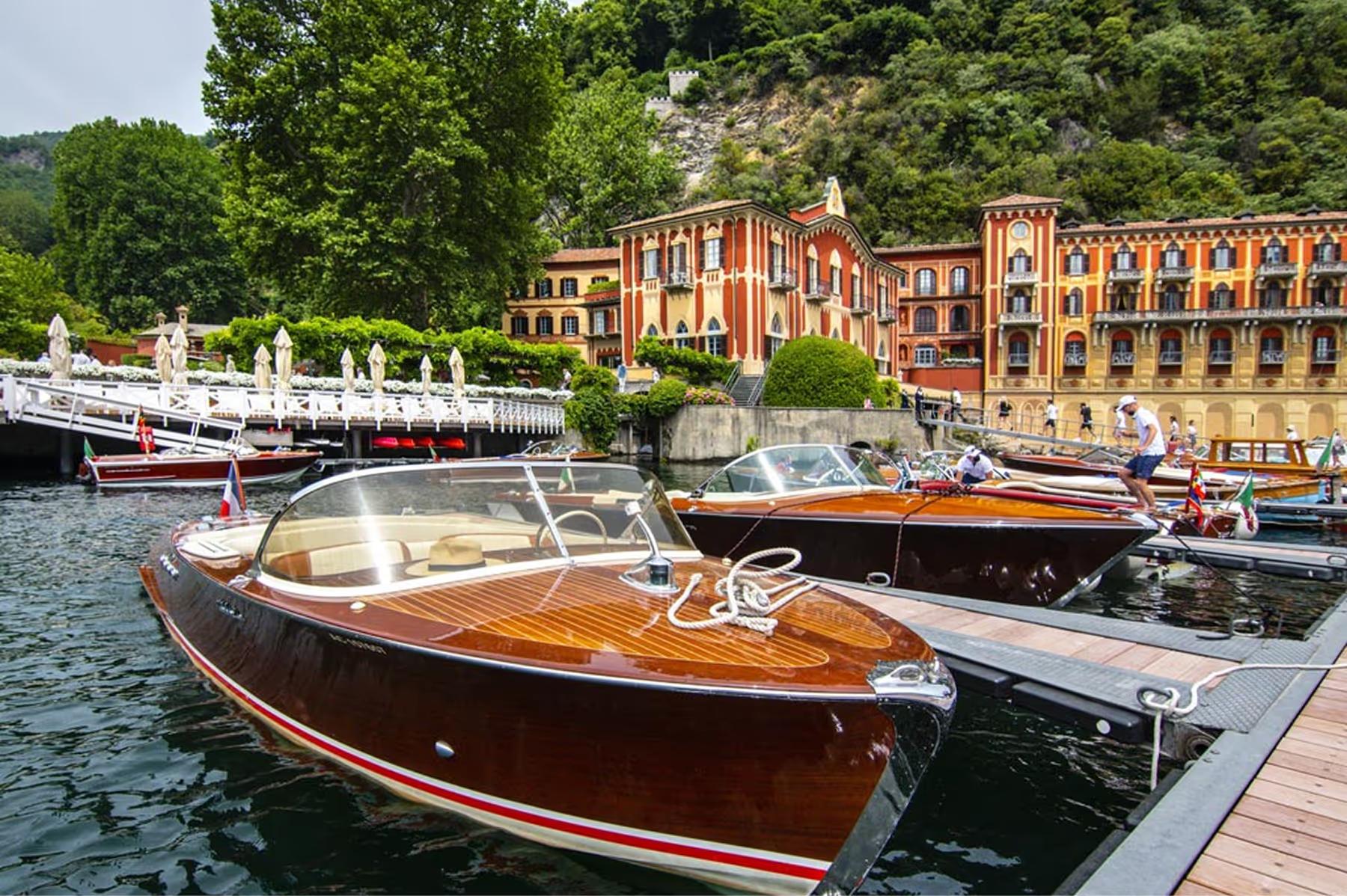 Moored wooden boats on the lake near the palazzo waterfront