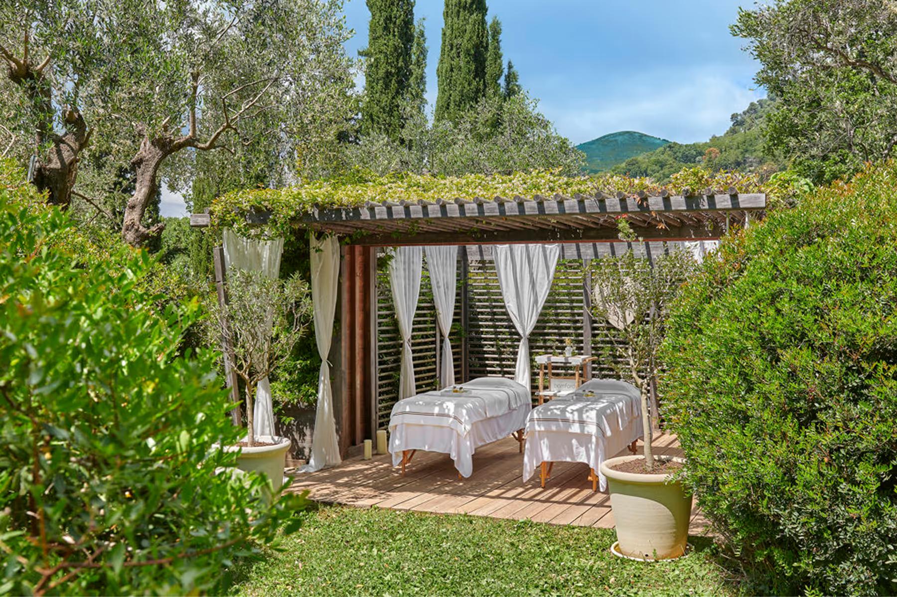 Château Saint Martin & Spa: garden cabana with pergola and lounge area near cypress-lined path