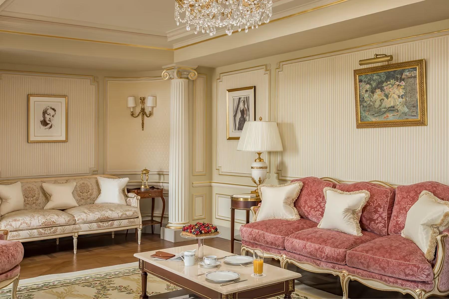 A suite in cream and rose tones with gilt furnishings and classical architectural moldings
