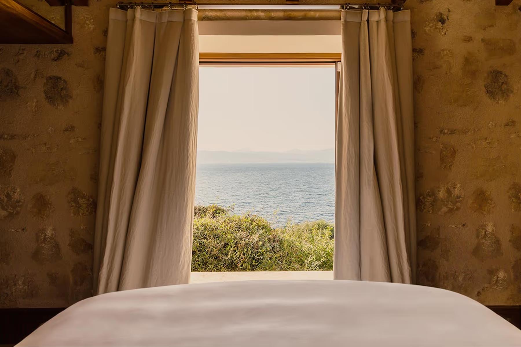 Cap Rocat: a covered terrace with cushioned loungers, wooden beams, and views of the Bay of Palma