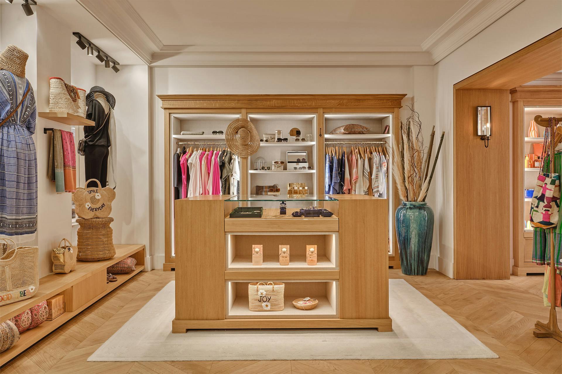 Château de La Messardière: walk-in dressing room with wooden cabinetry, shelving, and clothing hanging rails