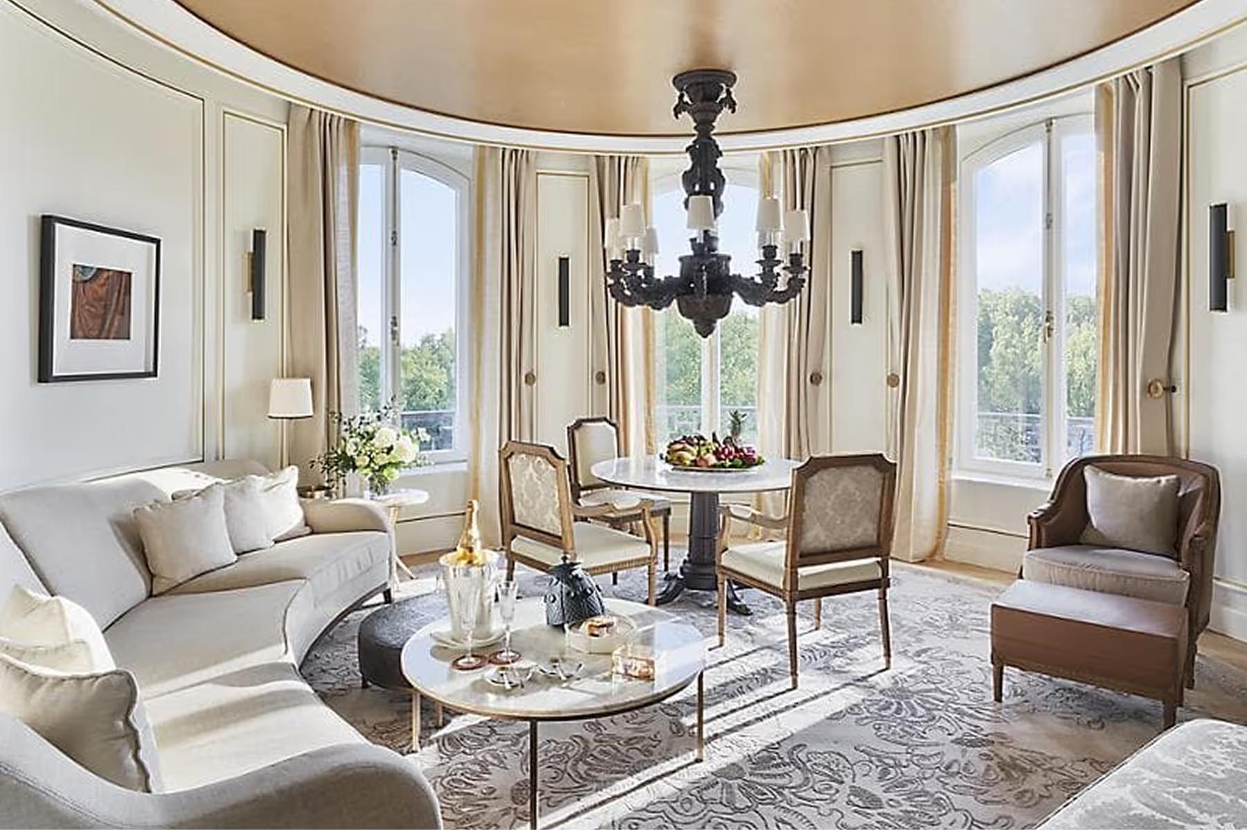 Mandarin Oriental Ritz, Madrid: curved parlor with black chandelier, upholstered seating, and inlaid marble floors