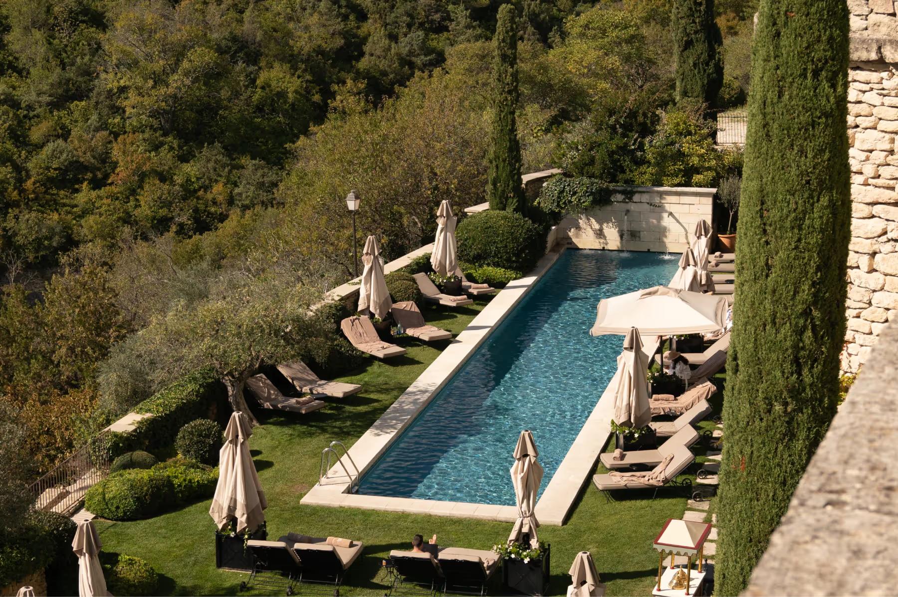 Terraced gardens with cypress, ivy-covered walls, and lounge seating