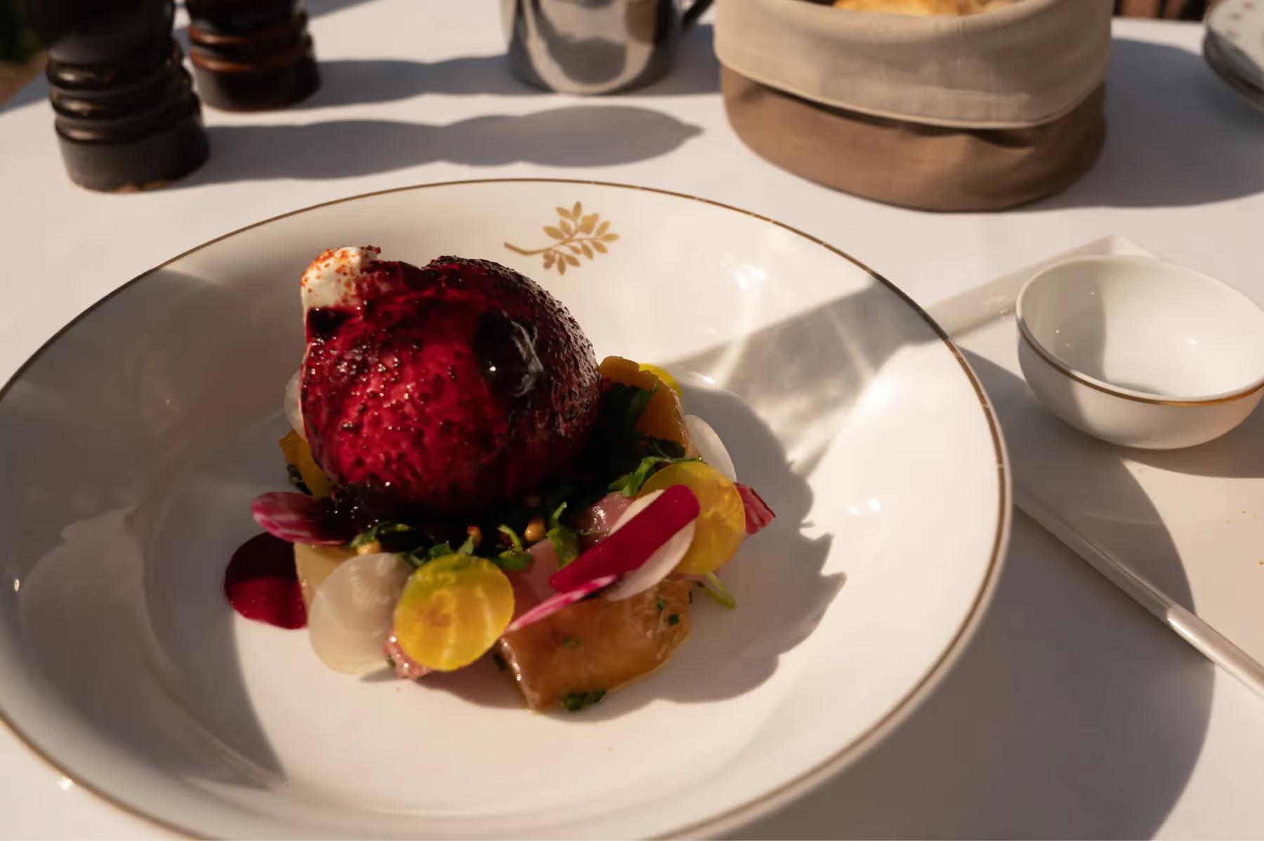 Airelles Gordes, La Bastide: plated dessert with red berry coulis and gold leaf accent