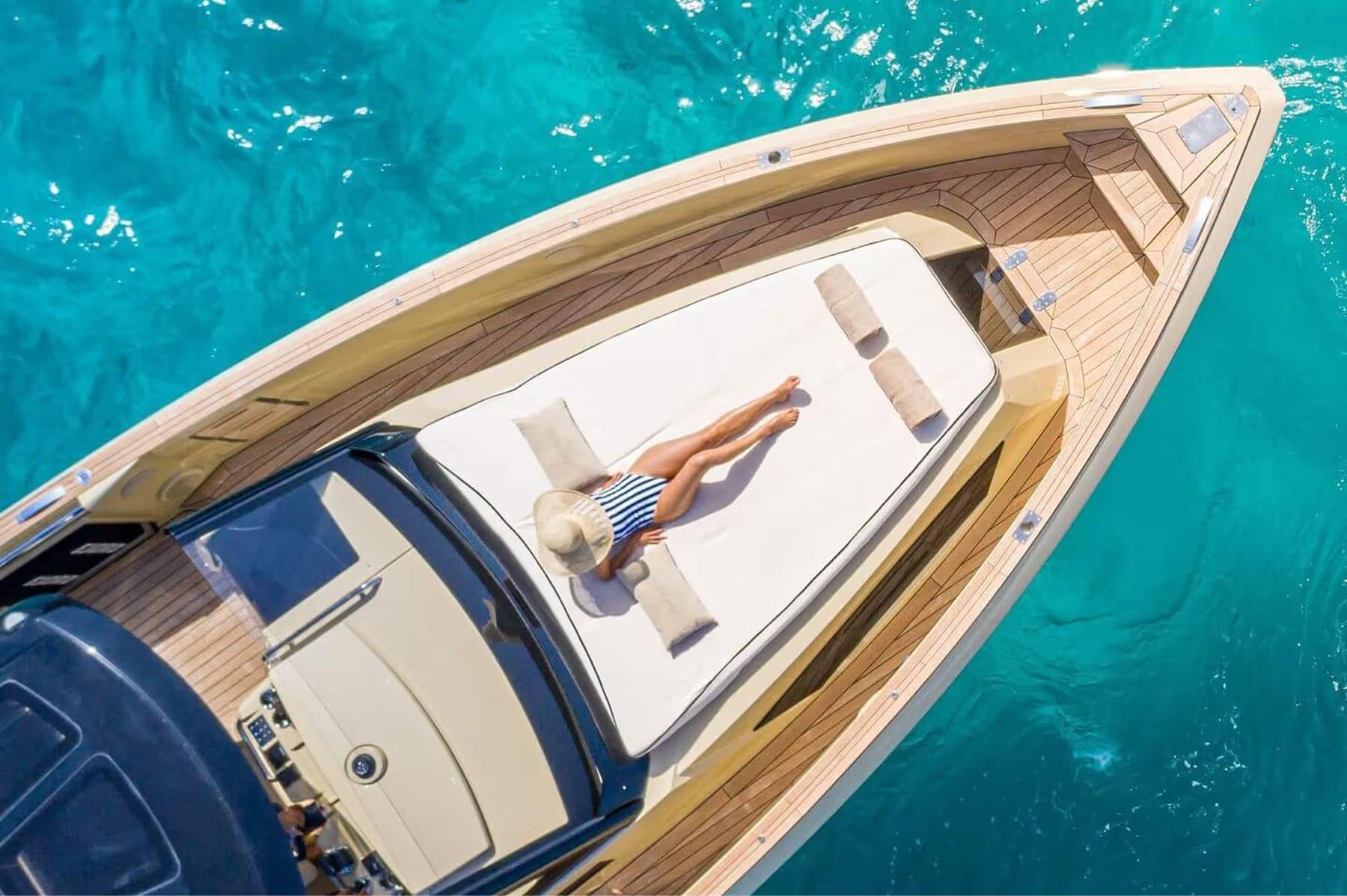 Cap Rocat: a gleaming white yacht hull overhead shows glass windows and the transparent turquoise sea