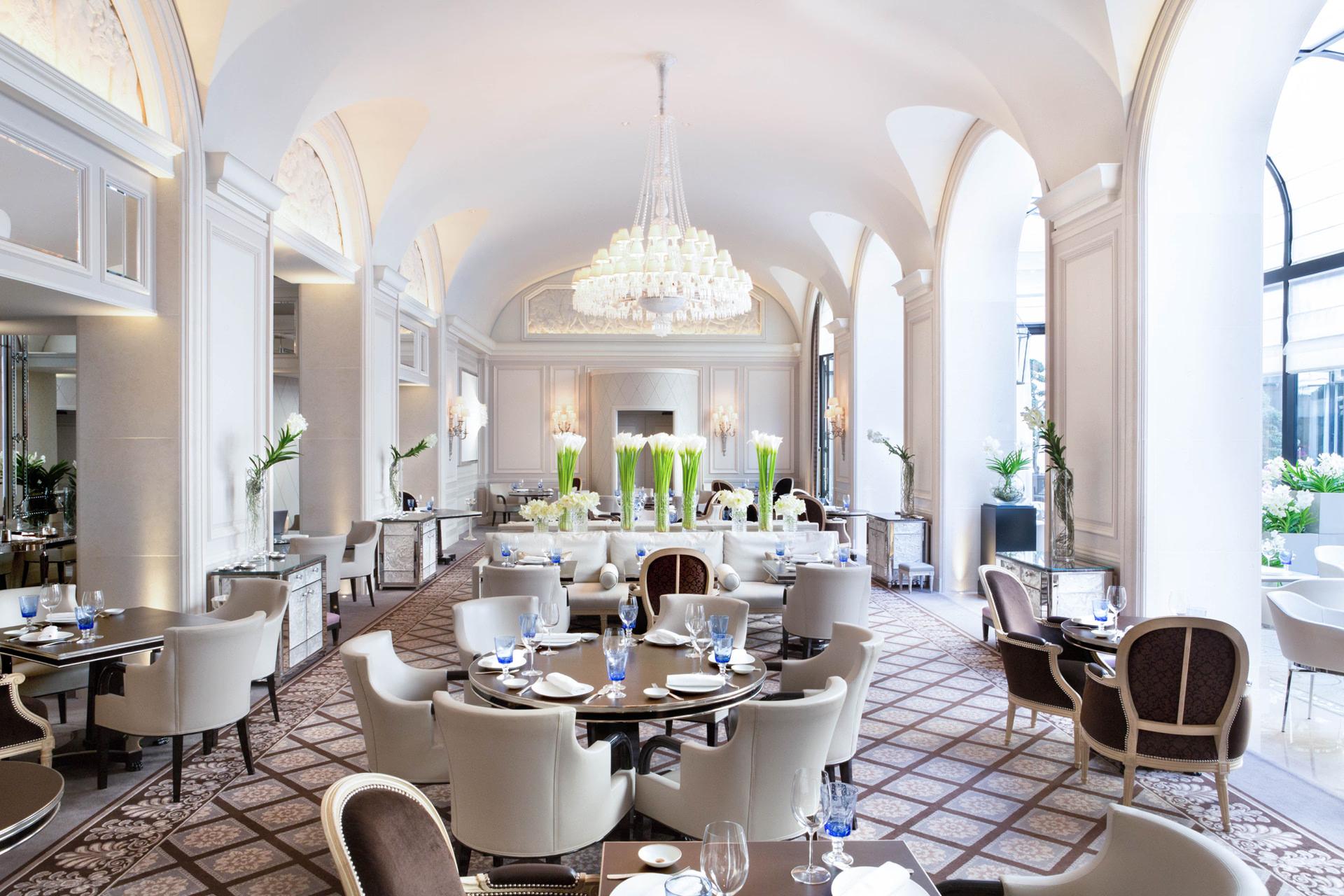 Four Seasons Hotel George V: a covered courtyard with pink bougainvillea cascading down dark trellis structures