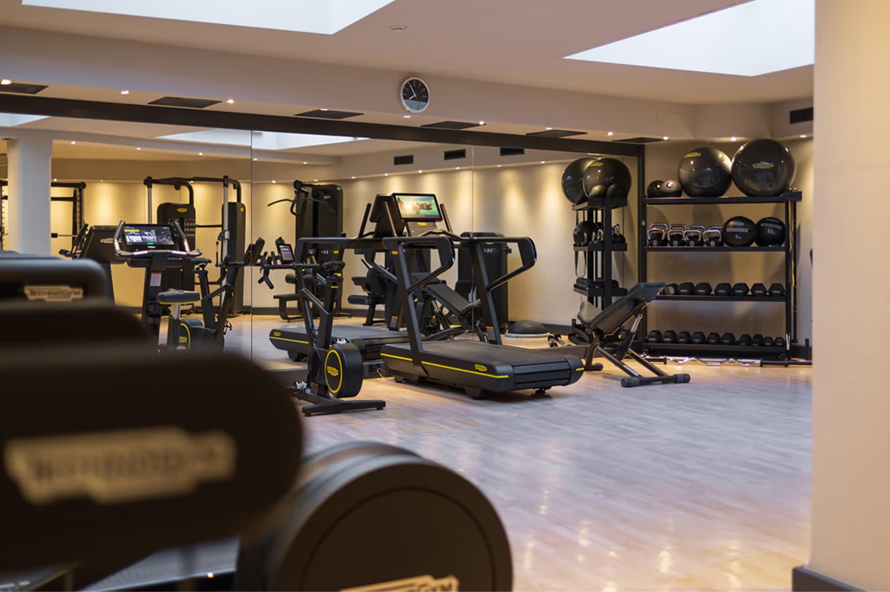 Fitness center with exercise equipment and bright natural lighting