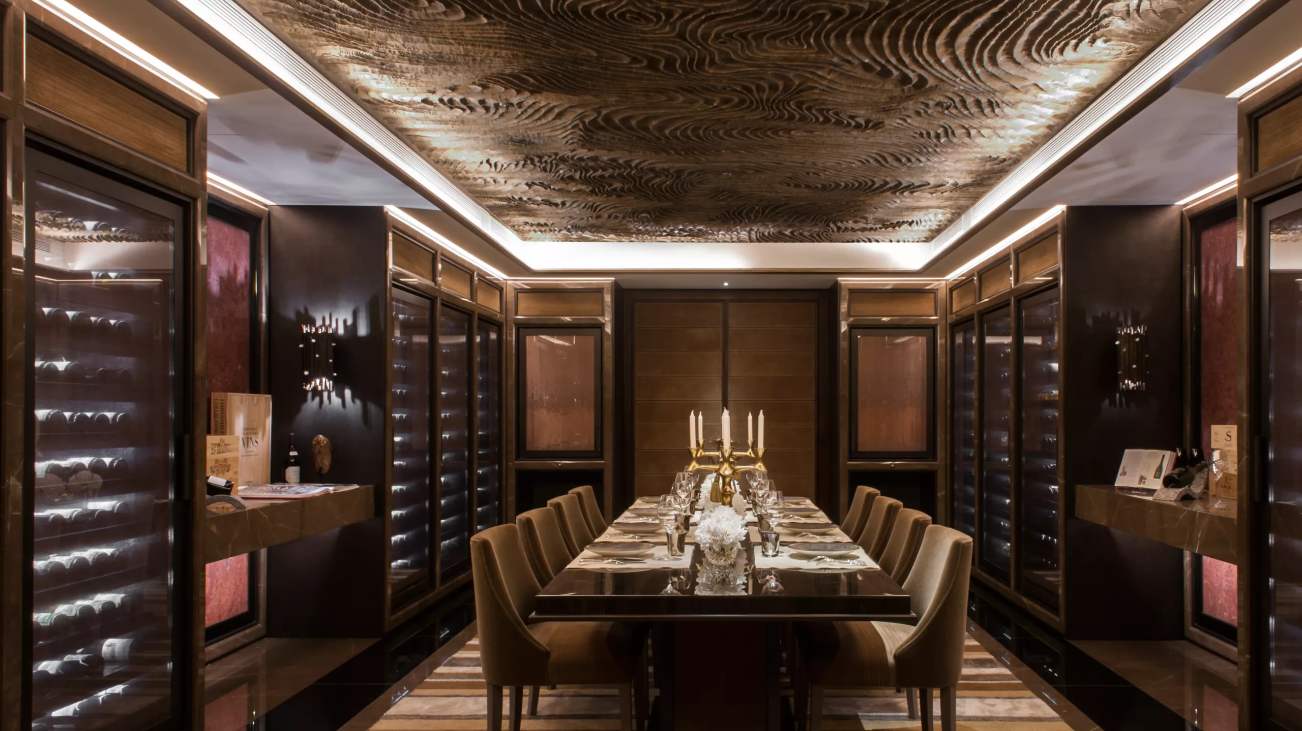 Intimate dining room with dark wood walls and elegant table settings