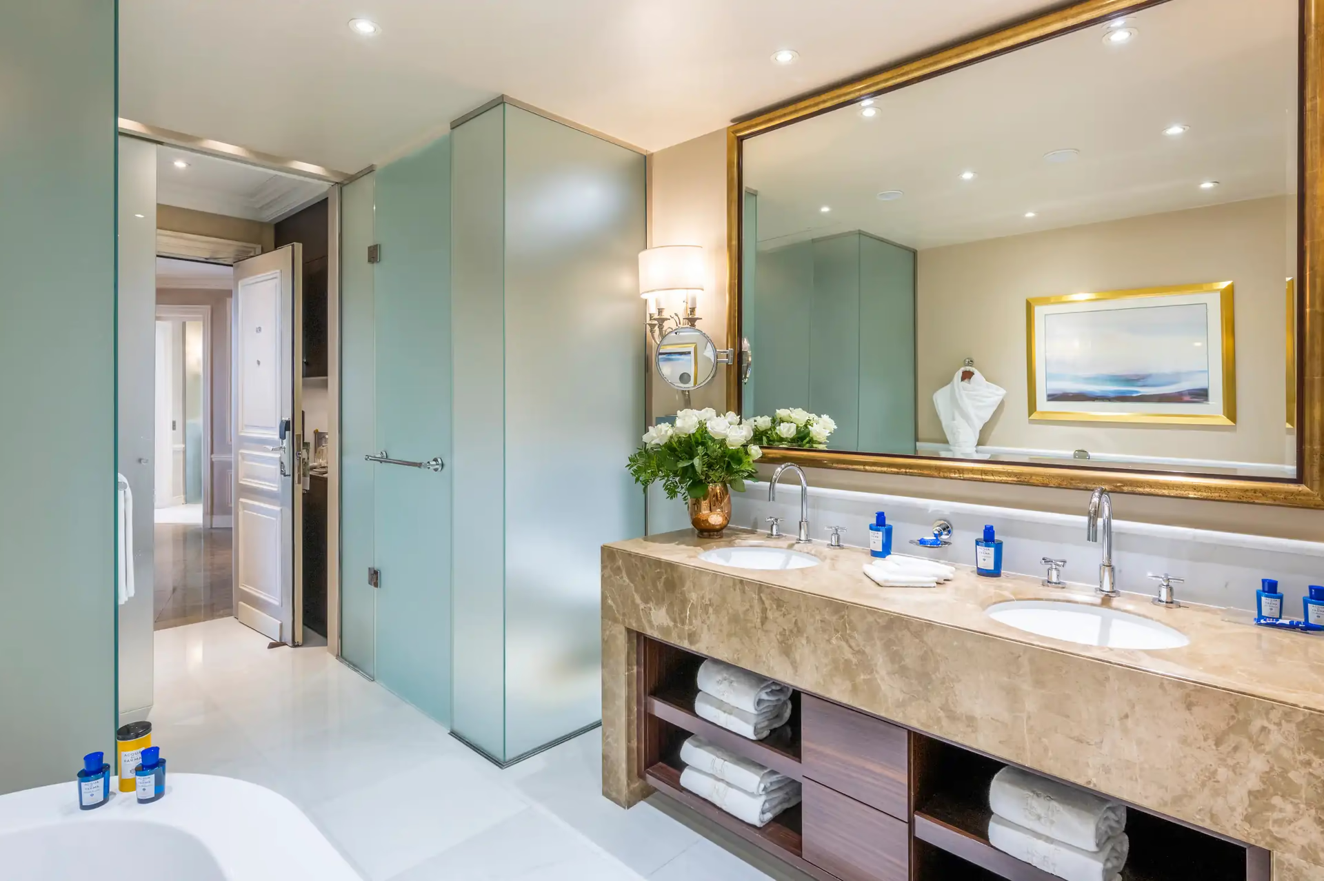 Hôtel Hermitage Monte-Carlo: marble bathroom with soaking tub, brass wall sconce and warm lighting