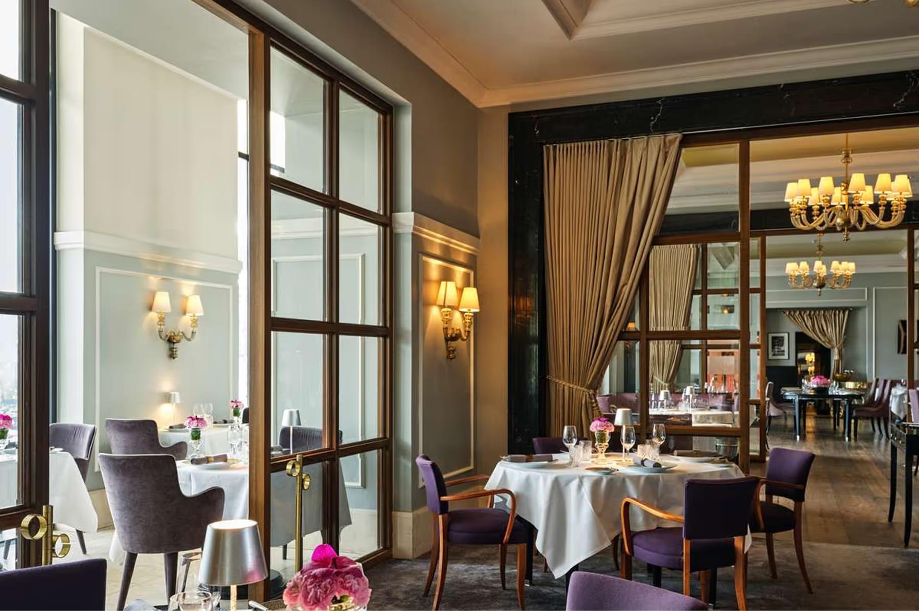 Hotel d’Angleterre: dining room with brass fixtures, burgundy accents, and mirrored walls