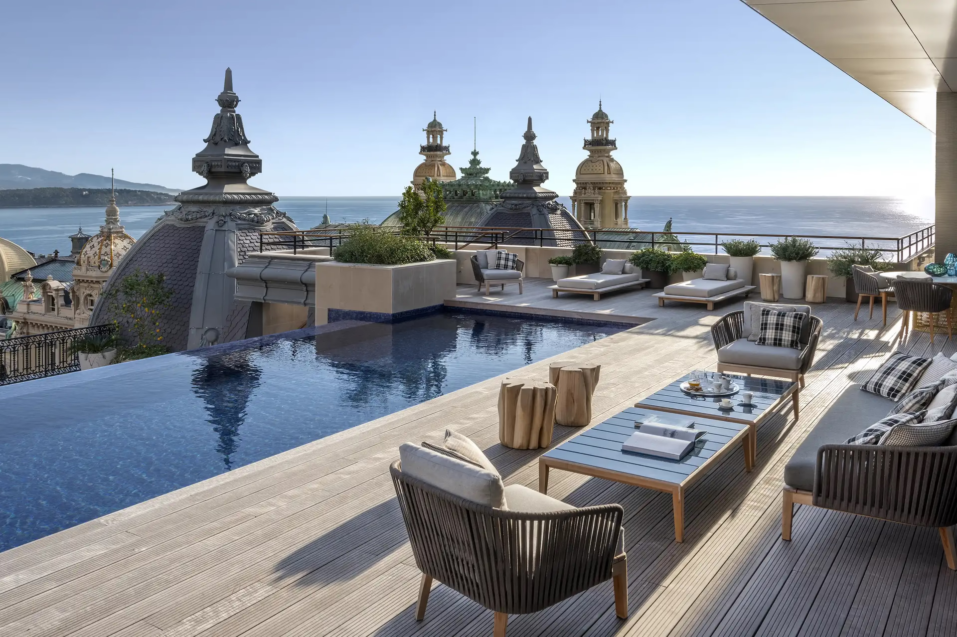 Hôtel de Paris Monte-Carlo: rooftop terrace with lounge chairs, pool and palazzo views overlooking sea