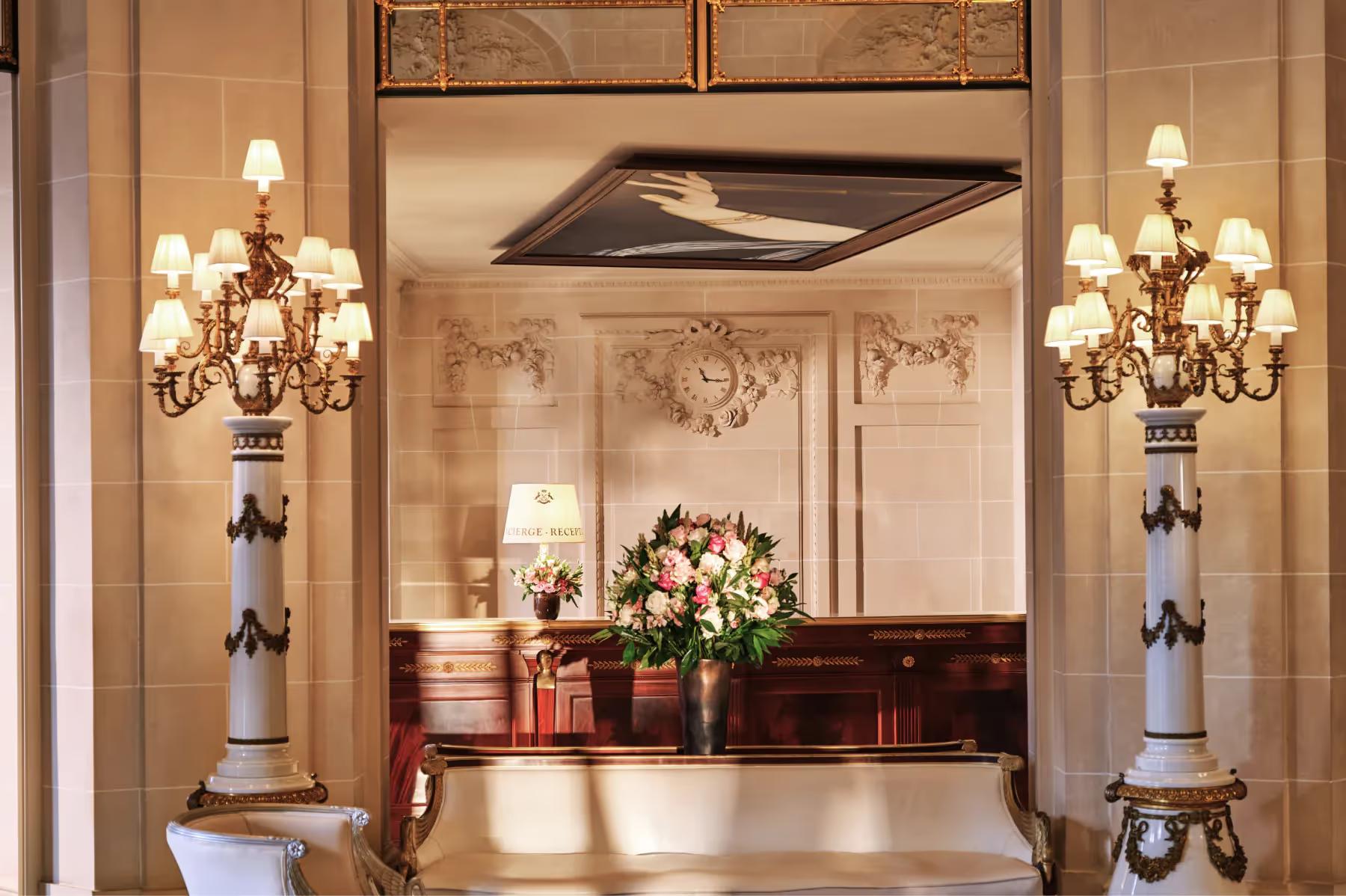 Le Meurice: an ornate entrance hall with gilt mirrors, classical sculptures, and marble columns