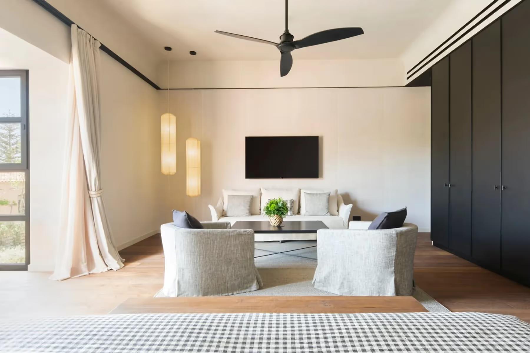 Can Ferrereta: bedroom with soft lighting and minimalist interior design