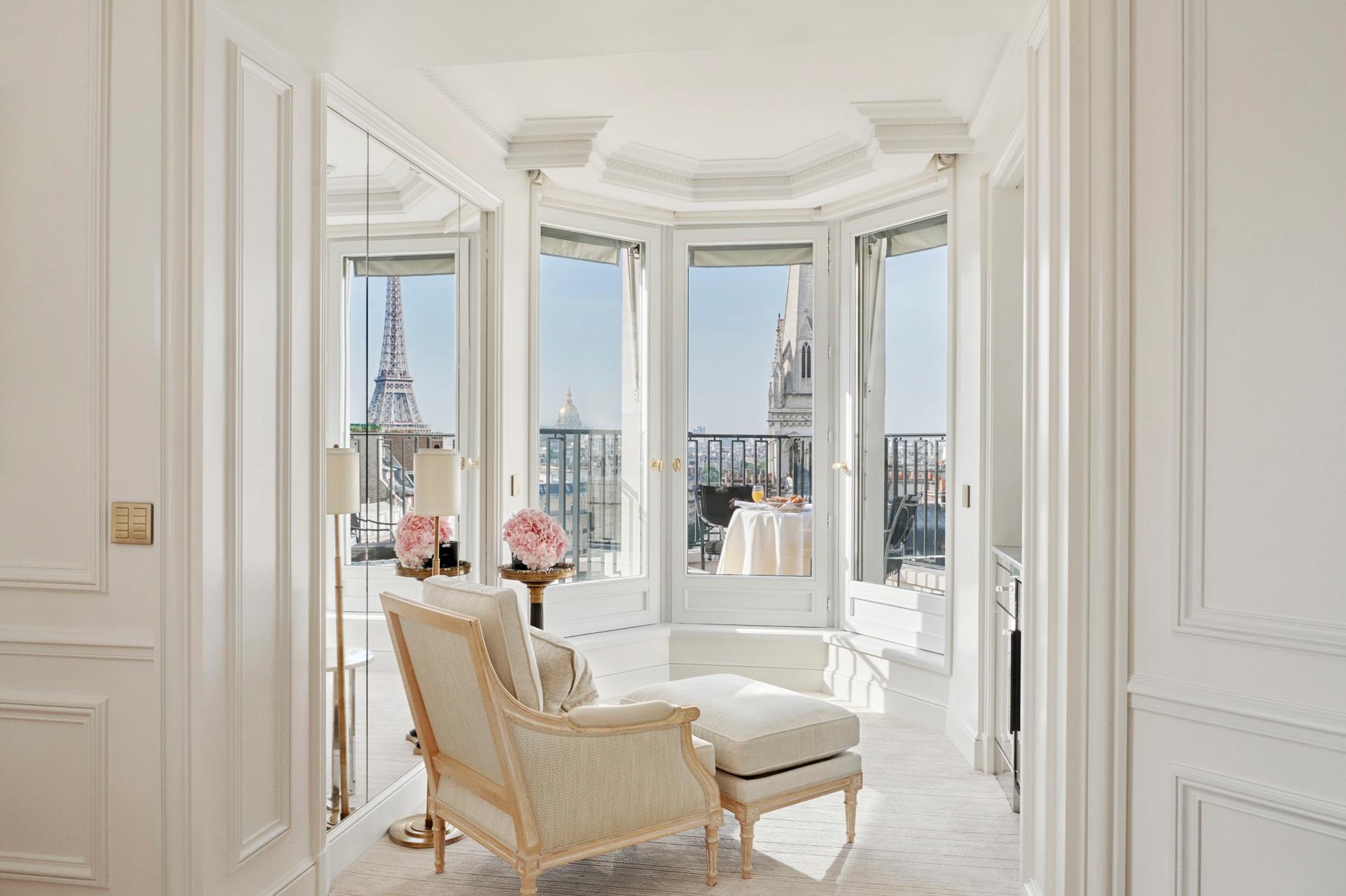 Four Seasons Hotel George V: a bay window seating nook with cream upholstery facing the Eiffel Tower
