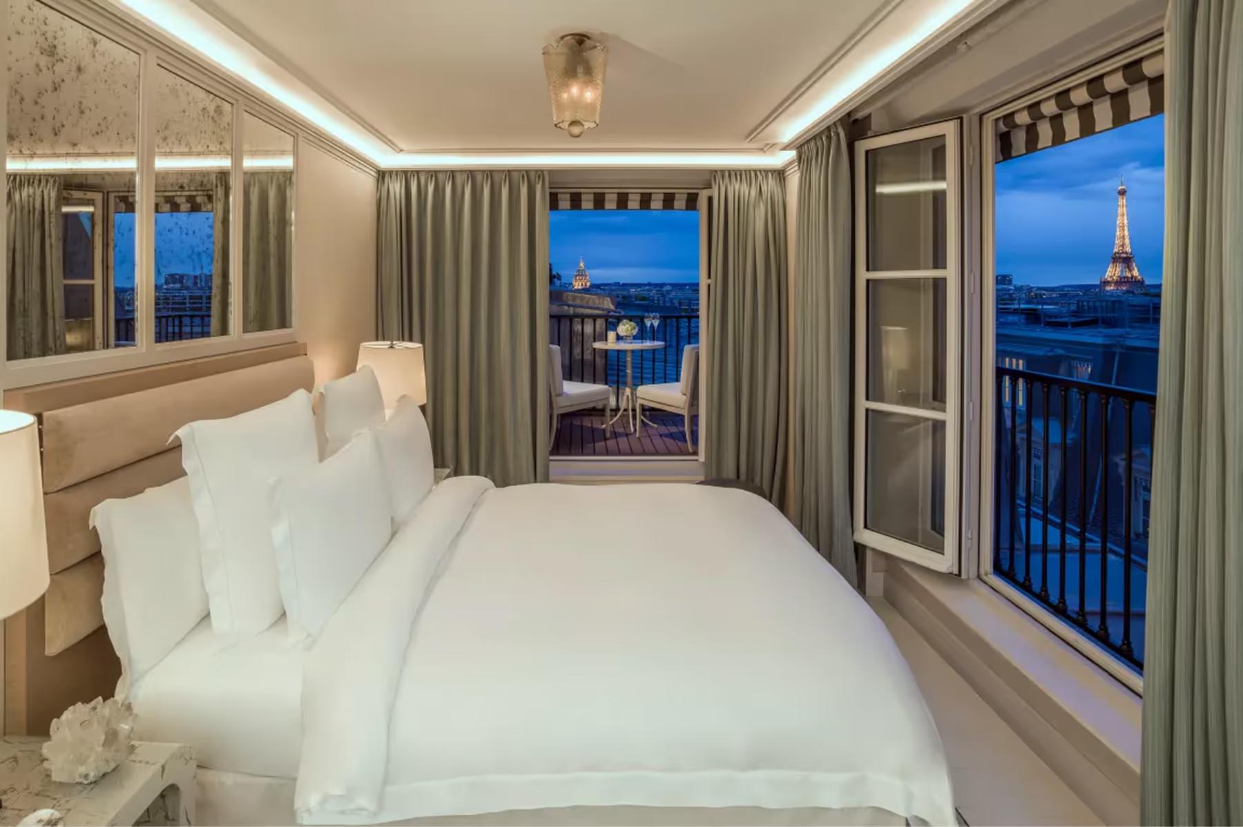 Hôtel de Crillon: bedroom with views of Eiffel Tower at dusk through tall French windows