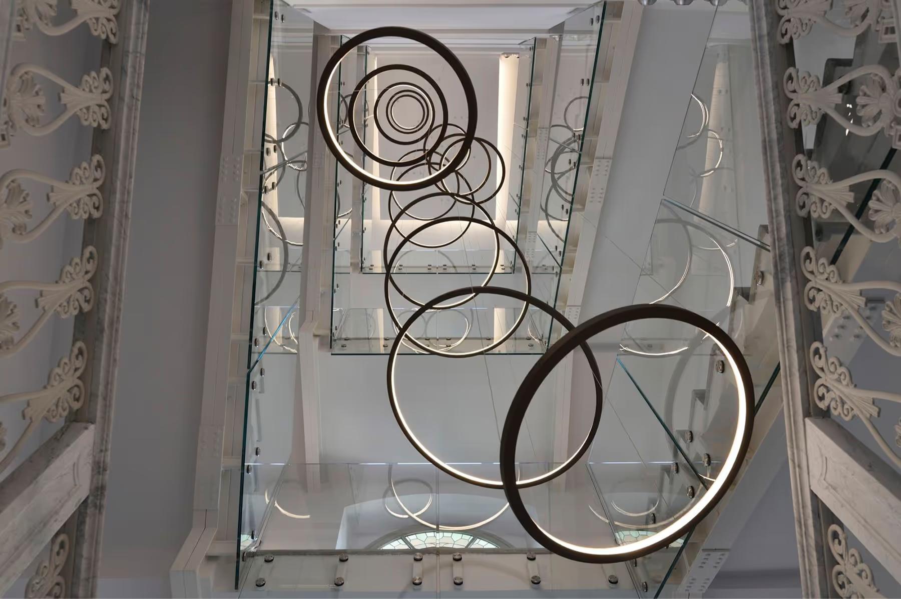 A geometric ceiling detail with white molding and circular patterns