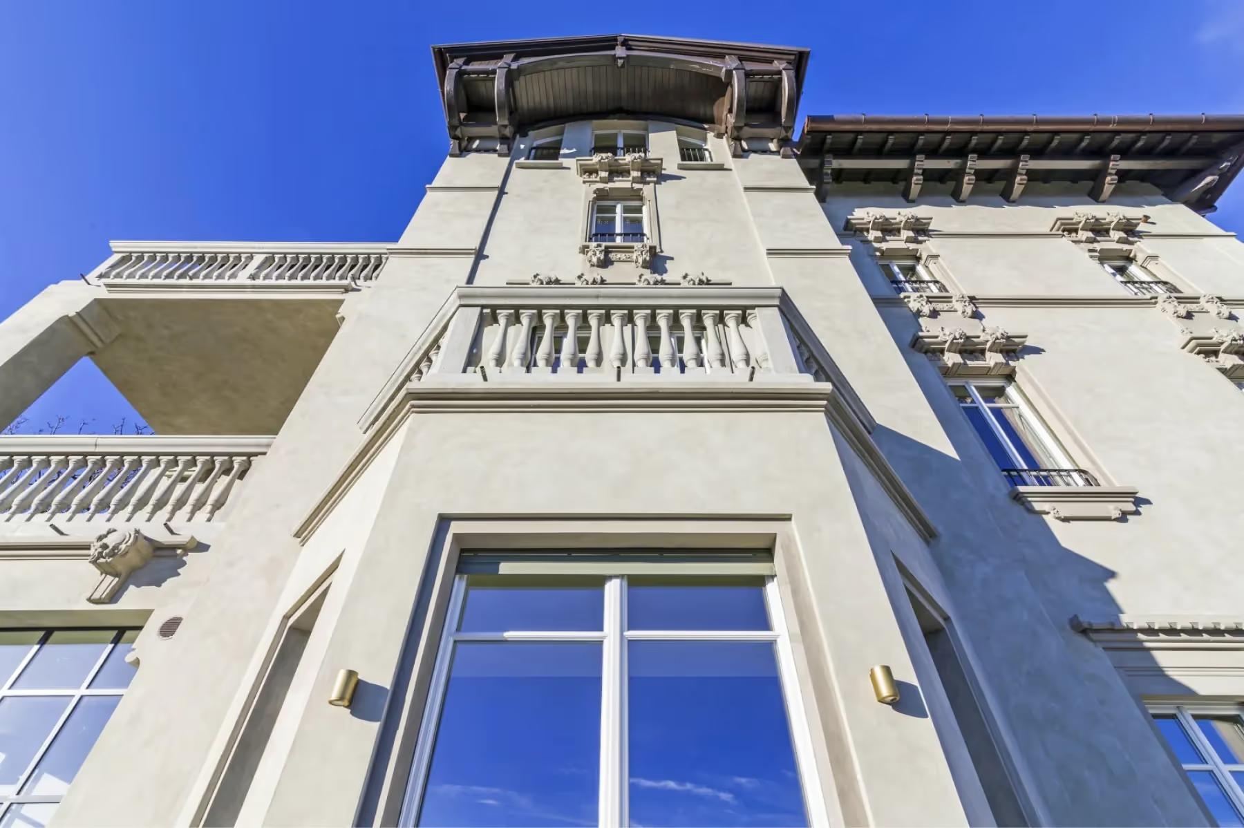 Villa Patrizia: the stone and stucco facade of the main villa with traditional balustrades