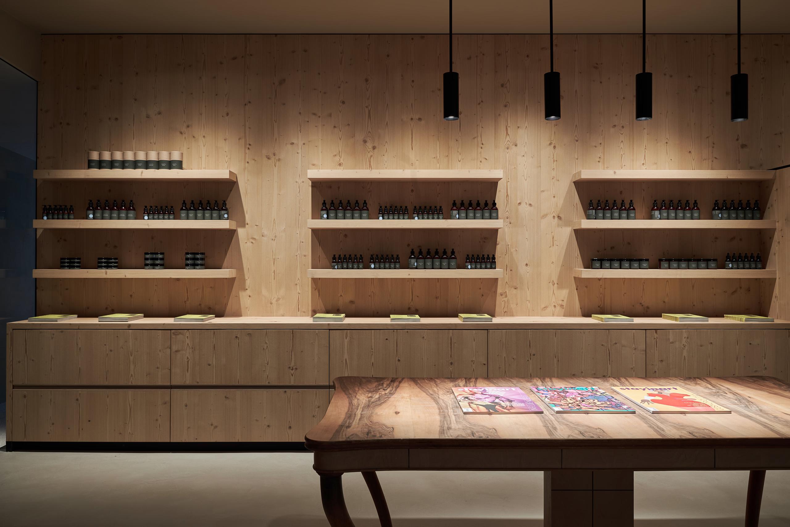 A quiet rest room with soft lighting, natural wood finishes, and minimal furnishings for relaxation