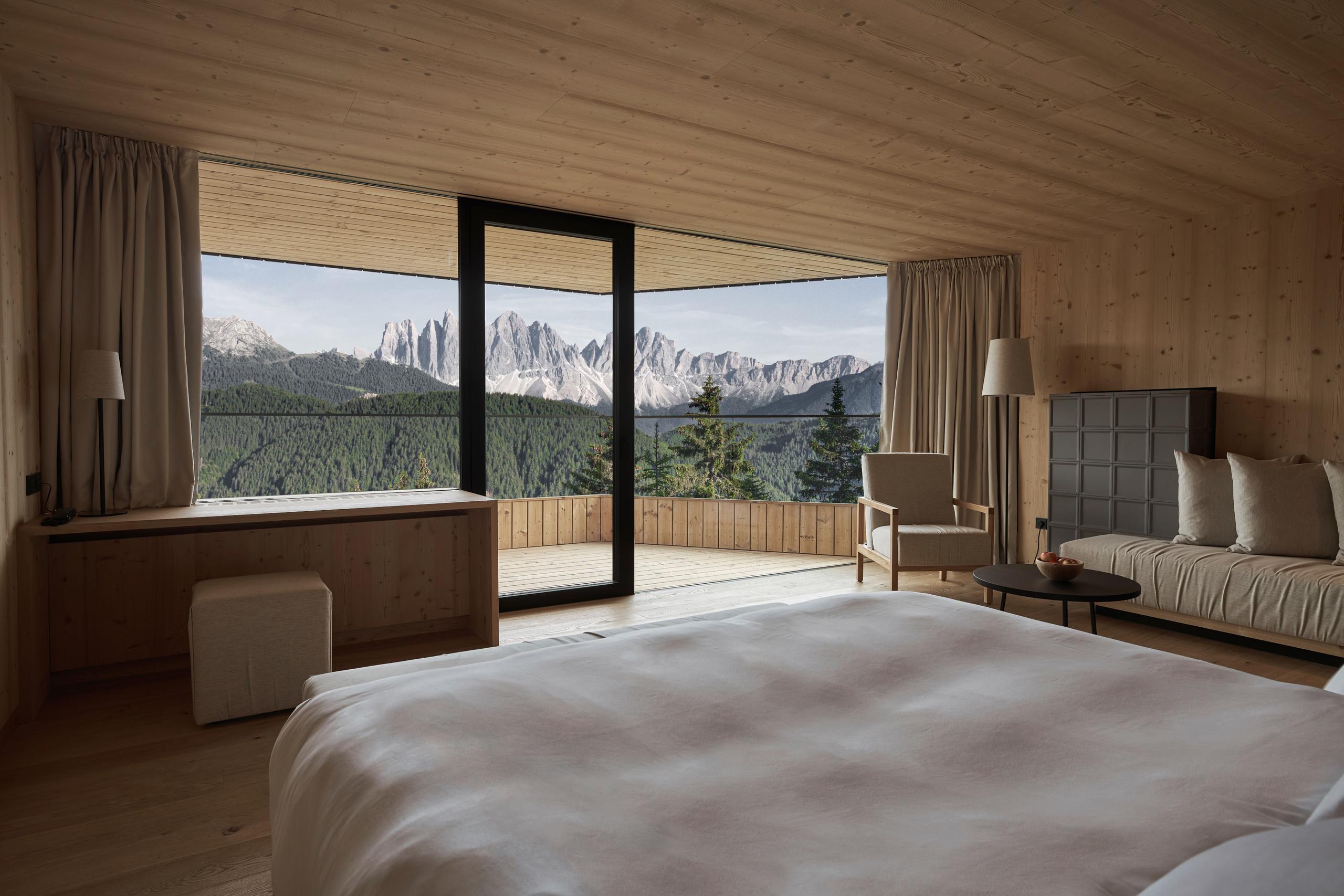 Forestis: a spa treatment room with stone surfaces, wood elements, and a minimalist layout for wellness services