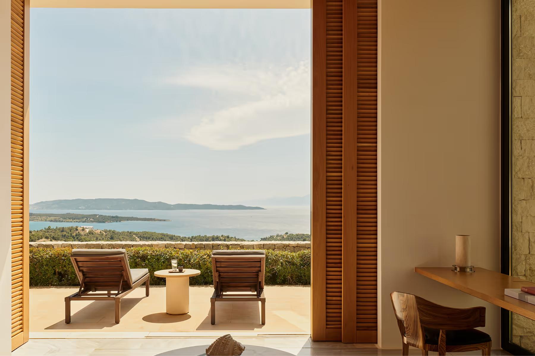 Terrace seating with unobstructed views of the Aegean at sunset