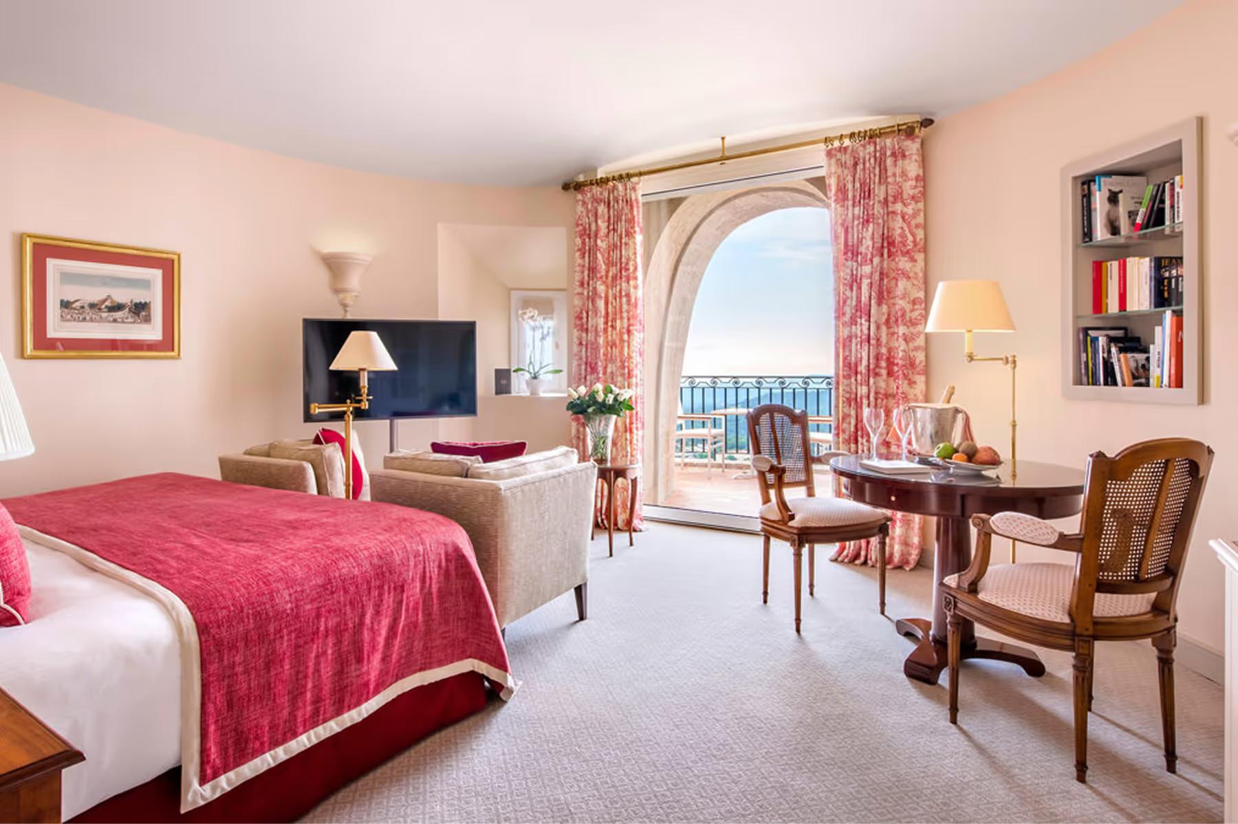 Château Saint Martin & Spa: suite bedroom with French doors opening to a terrace with sea views