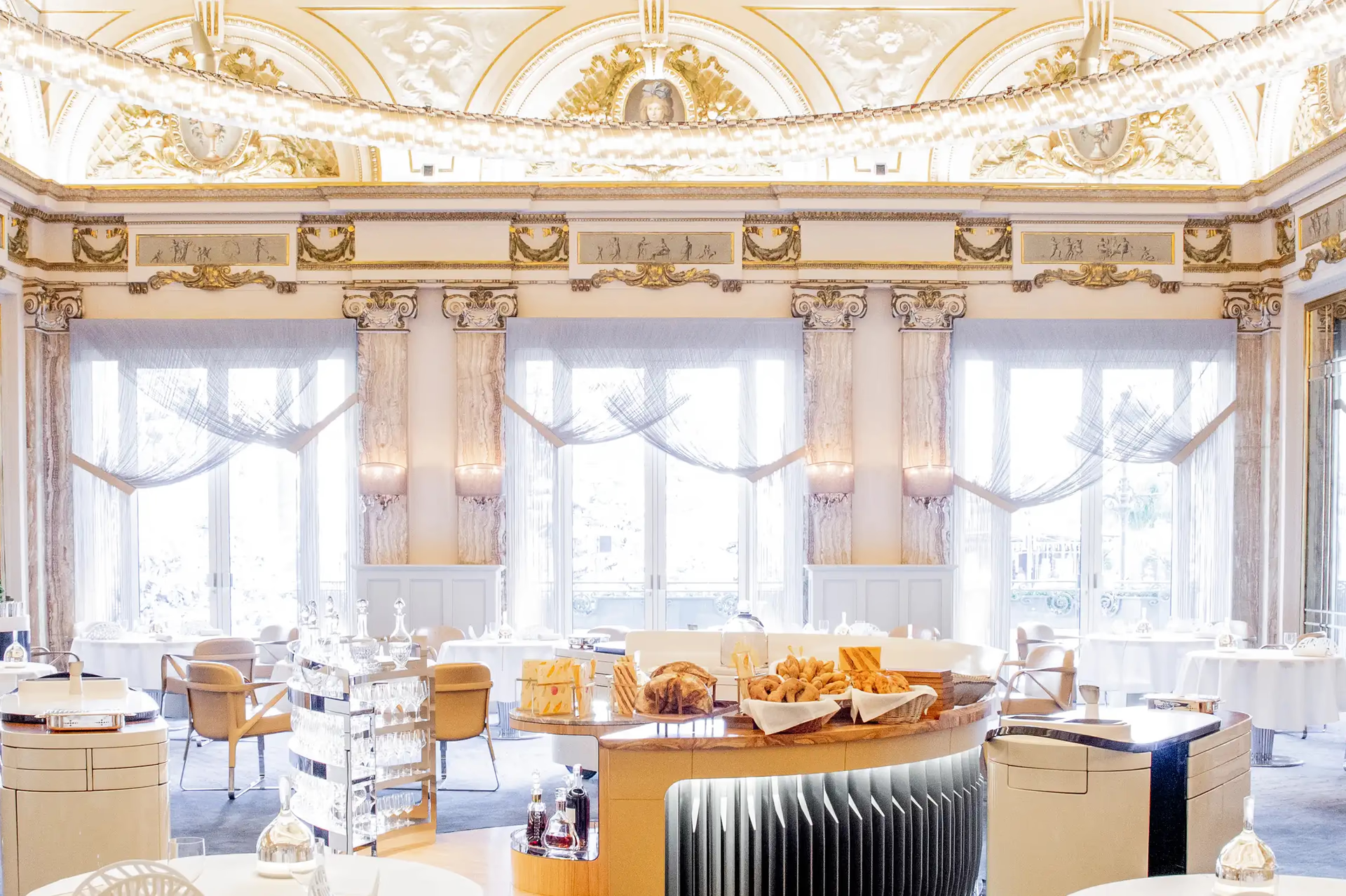 Hôtel de Paris Monte-Carlo: dining room with grand painted ceiling, gilt columns, and large windows with drapes