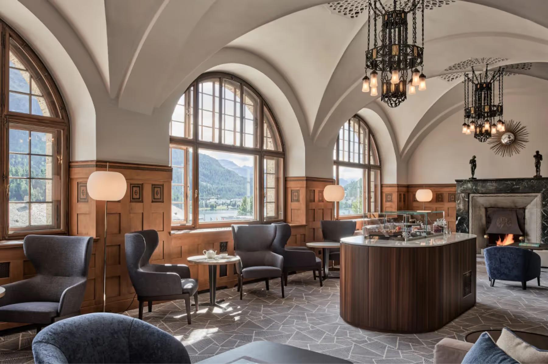 Grace La Margna St. Moritz: grand lobby with arched ceilings, wooden bar, chandeliers, and alcove seating areas