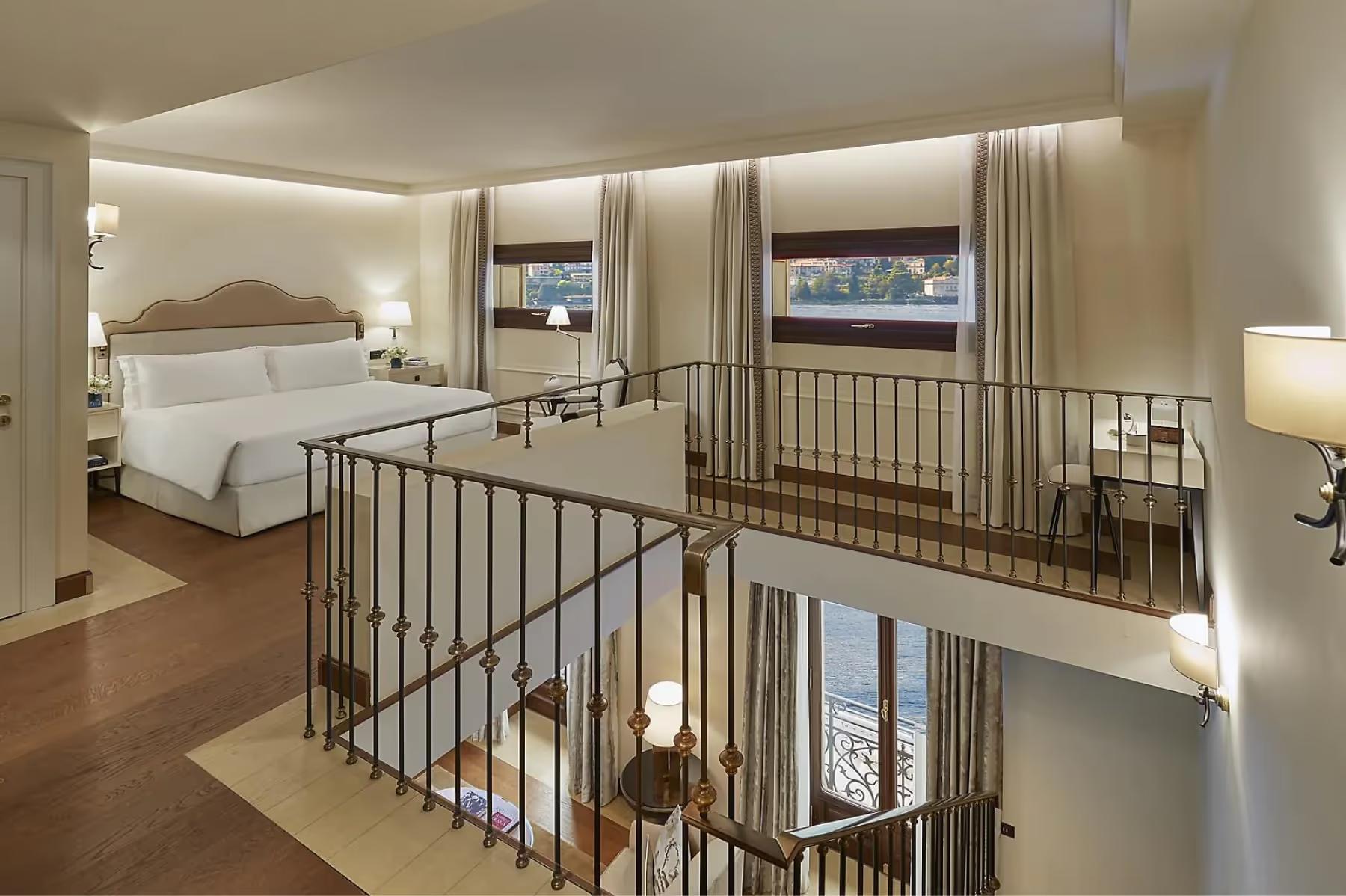 Mandarin Oriental, Lake Como: multi-level suite bedroom with railing mezzanine and expansive lake views through windows