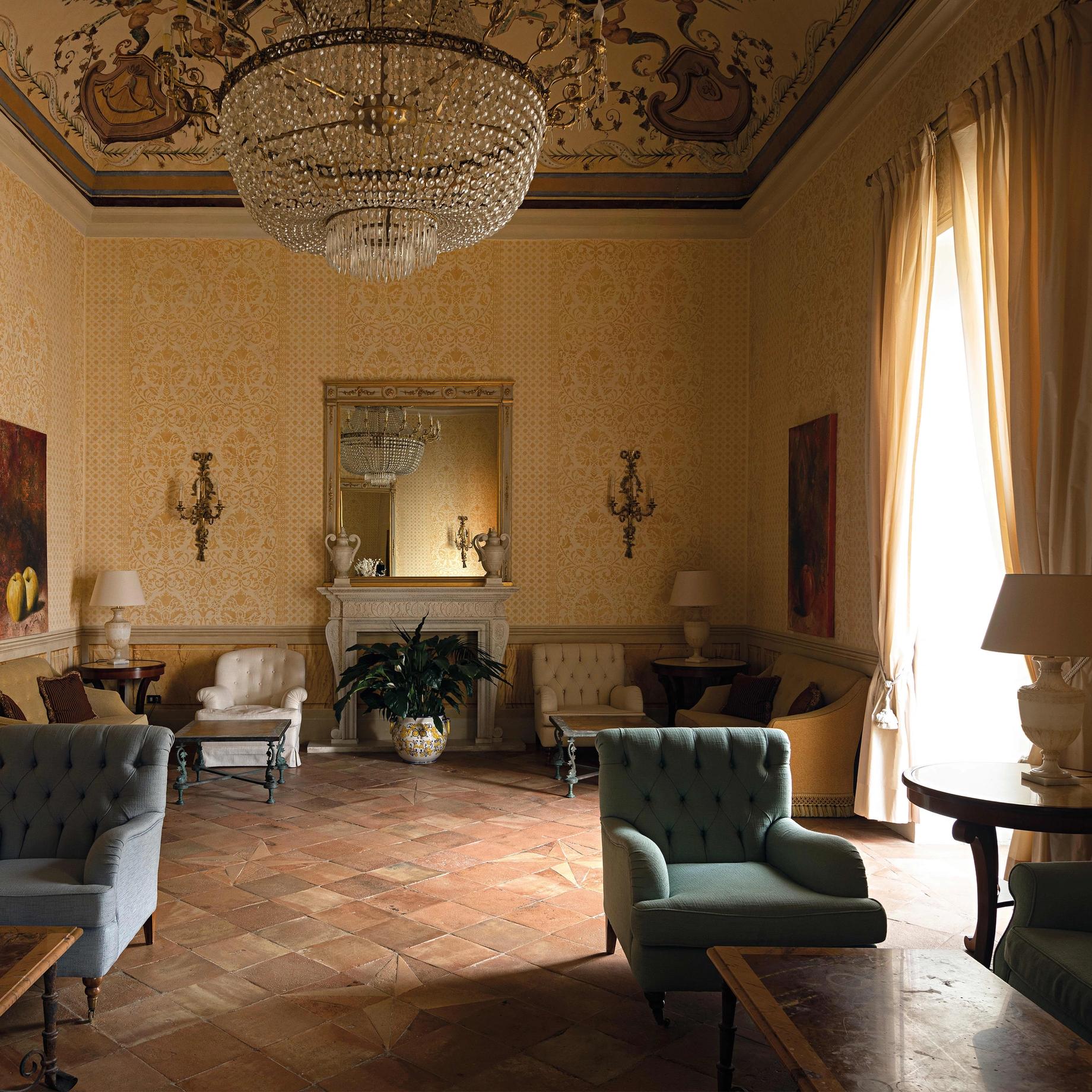 A tiled salon with a fireplace in a villa on the Amalfi Coast