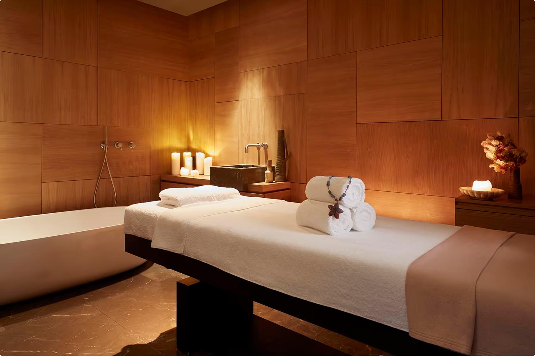 Mandarin Oriental Conservatorium, Amsterdam: spa massage treatment room with terracotta tile walls, treatment bed, and ambient lighting