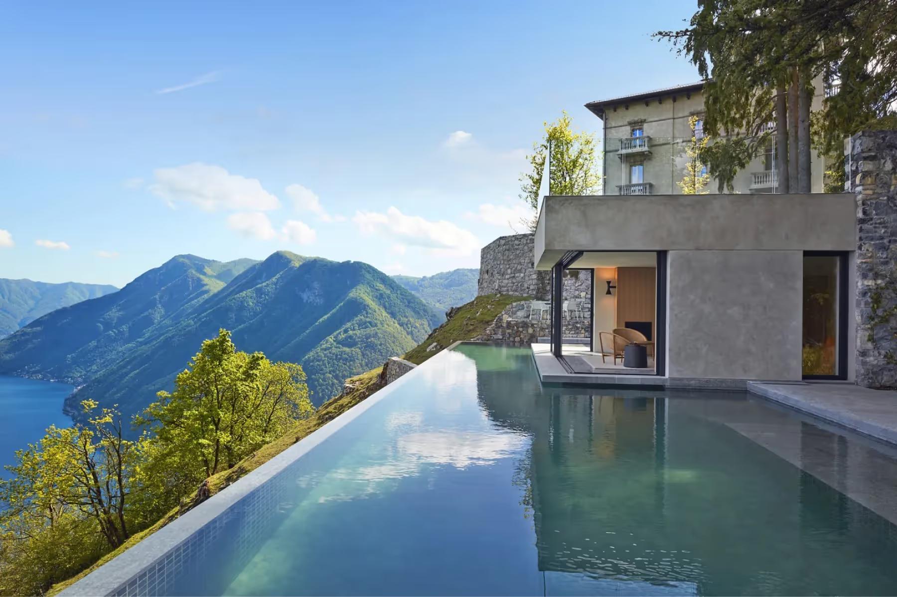 Villa Patrizia: a terraced infinity pool overlooking Lake Como and surrounding mountains under clear skies