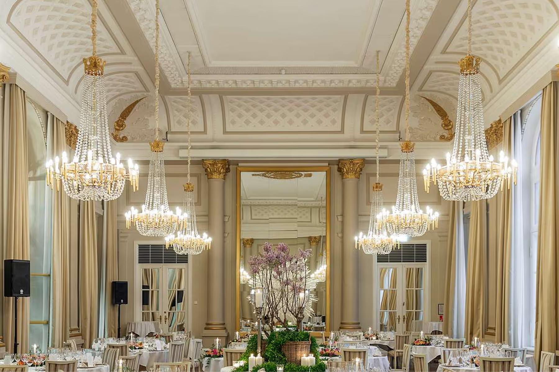 Grand ballroom with crystal chandeliers and neoclassical details