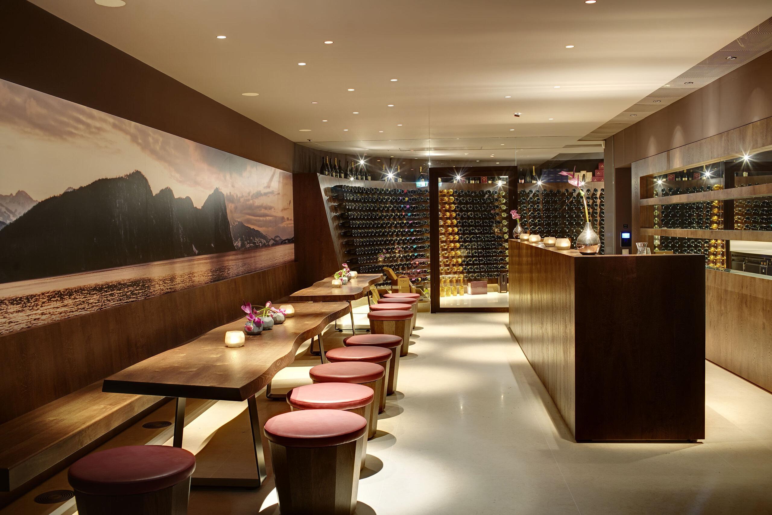 Park Hotel Vitznau: fine dining room with dark finishes, mountain photography, and ambient lighting