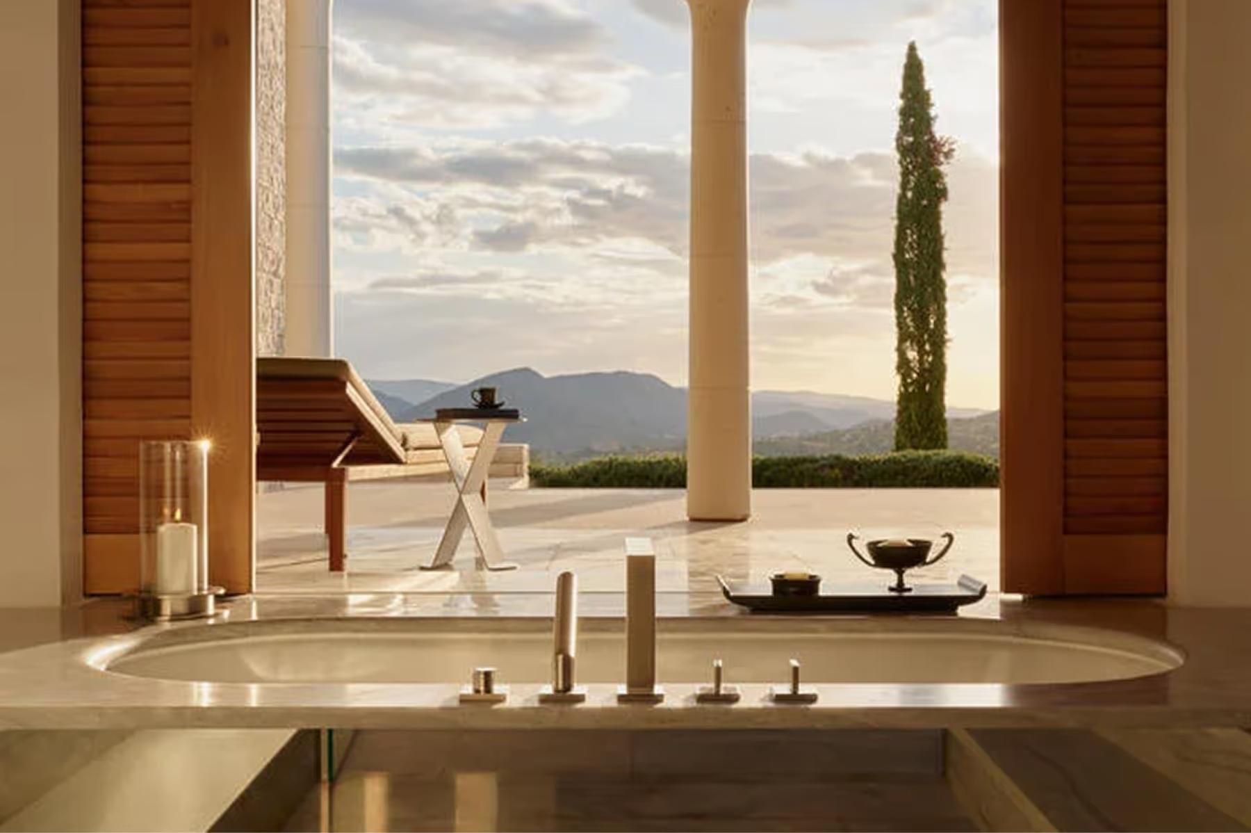 Modern stone villa exterior with cypress trees and sea horizon