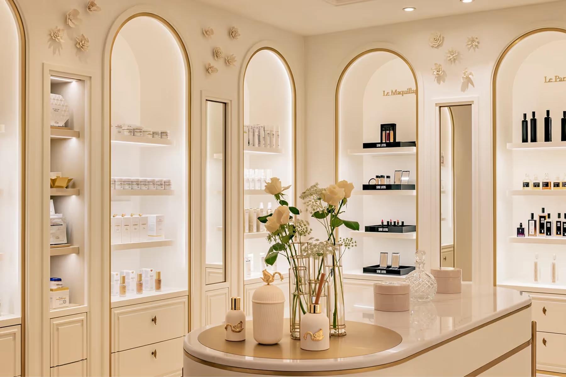 Ritz Paris: a beauty salon interior with illuminated arched mirrors and product display shelving
