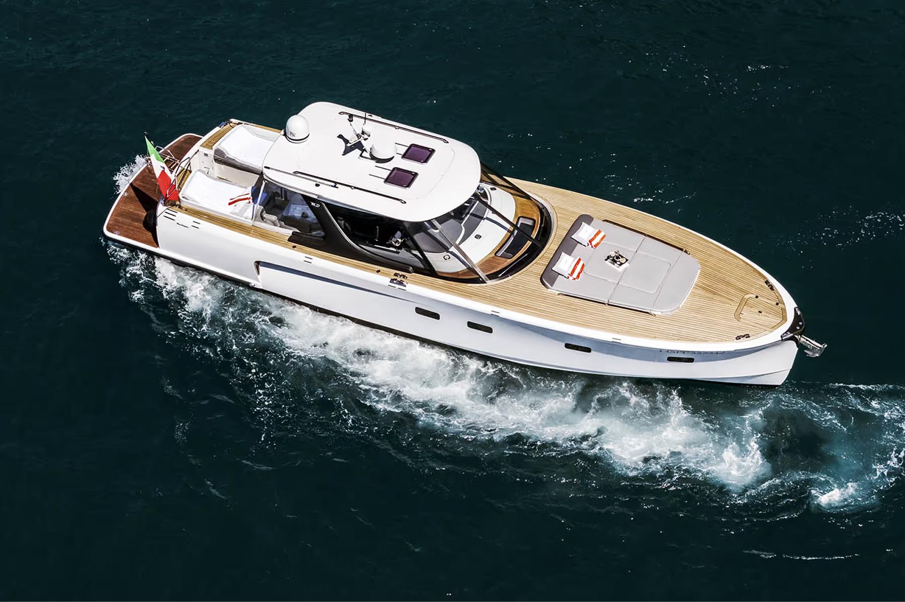 Luxury yacht cabin interior with dashboard, seating, and doors opening to sea view