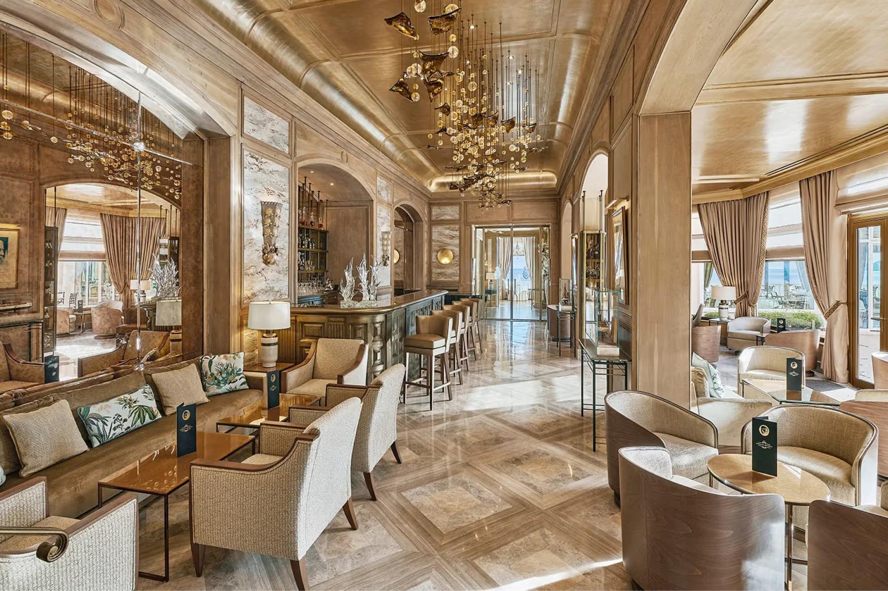 La Réserve de Beaulieu: spacious grand salon with connected dining areas and marble flooring