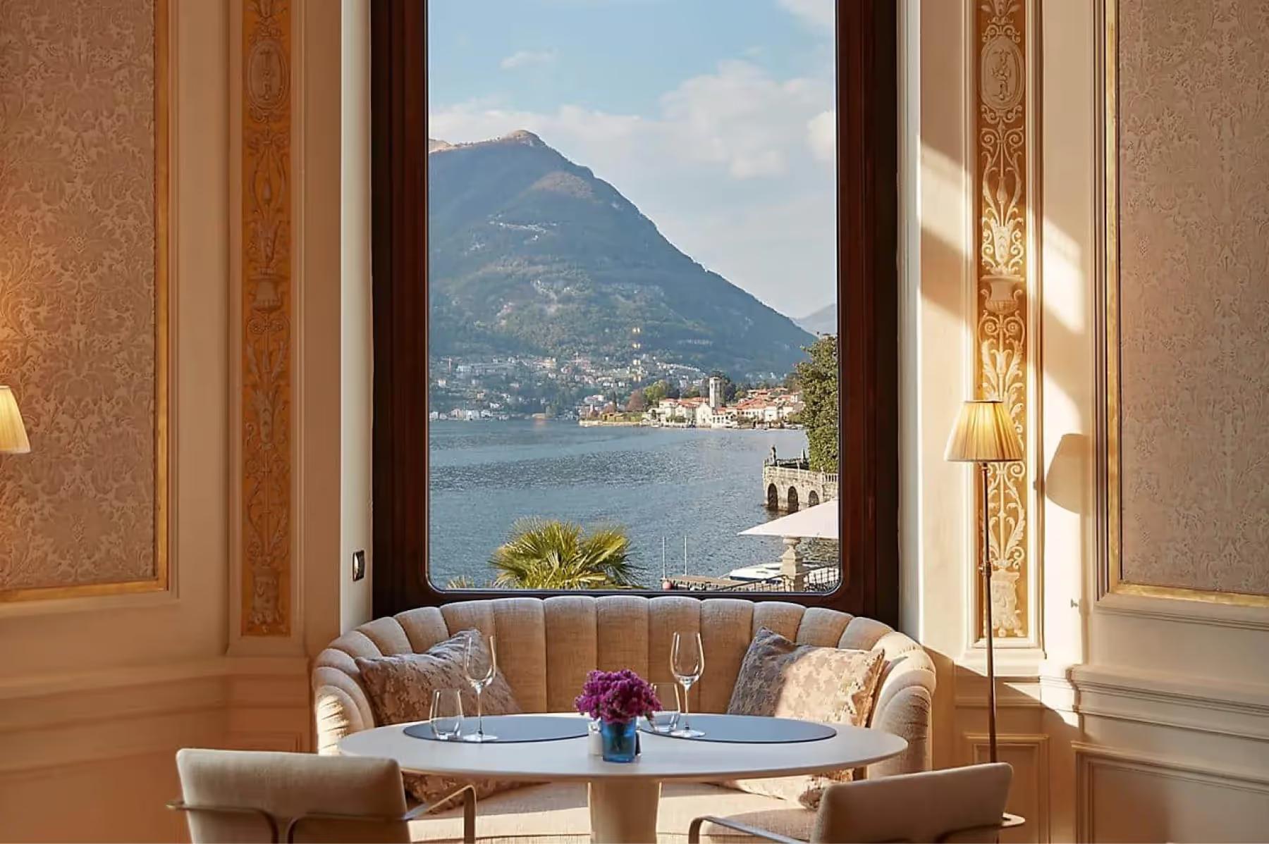 Mandarin Oriental, Lake Como: lounge room with arched windows framing lake and mountain vista, earth-toned seating