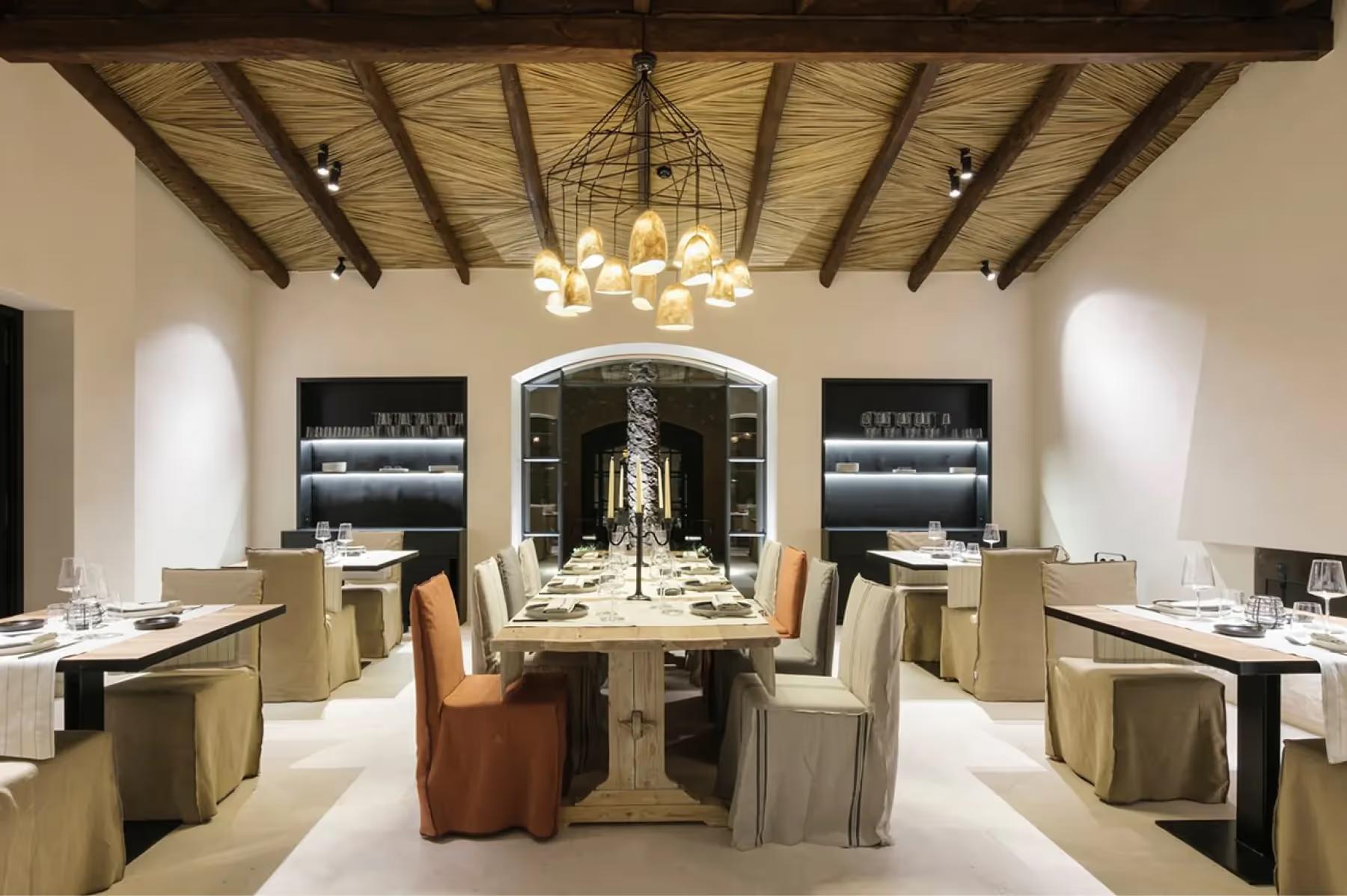 Can Ferrereta: elegant dining space with natural light and carefully arranged table settings