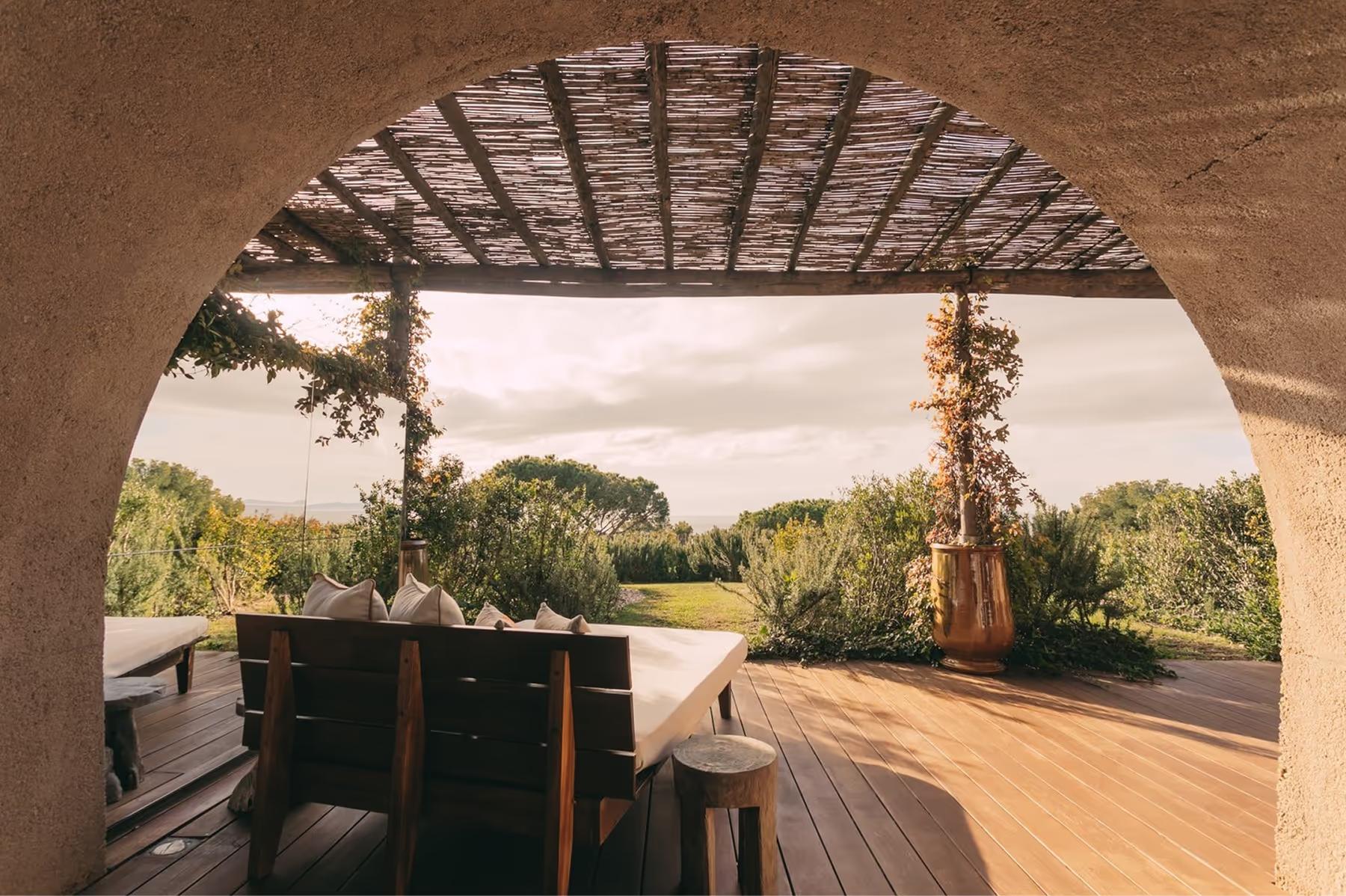 Sheltered terrace with wooden loungers overlooking forested hills