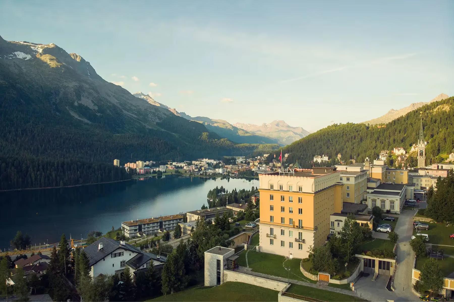 Kulm Hotel St. Moritz: the lakeshore with the hotel overlooking the water and Alpine slopes beyond