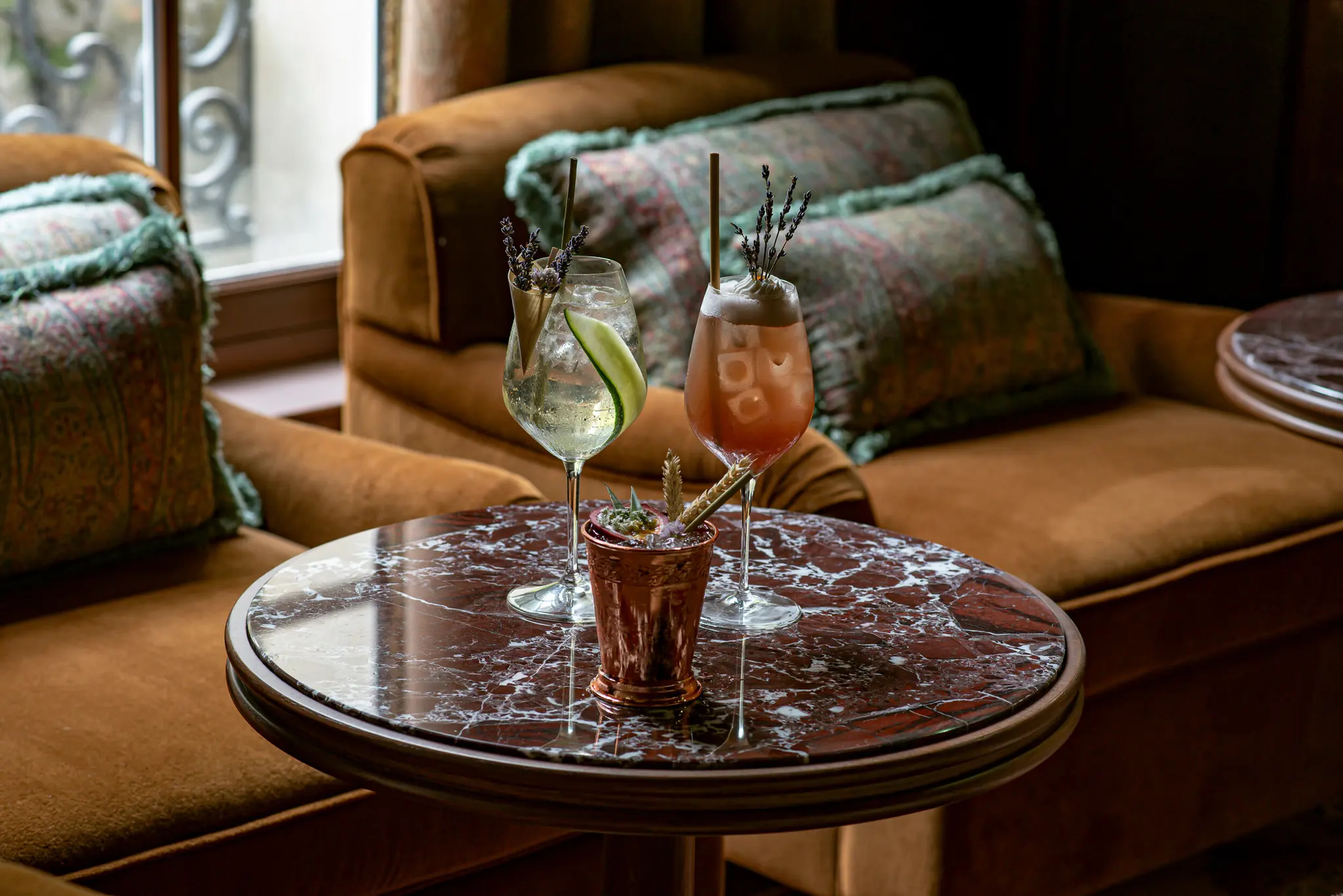Saint James: reception lounge with warm wood accents, orchid arrangement, and classical architectural detail
