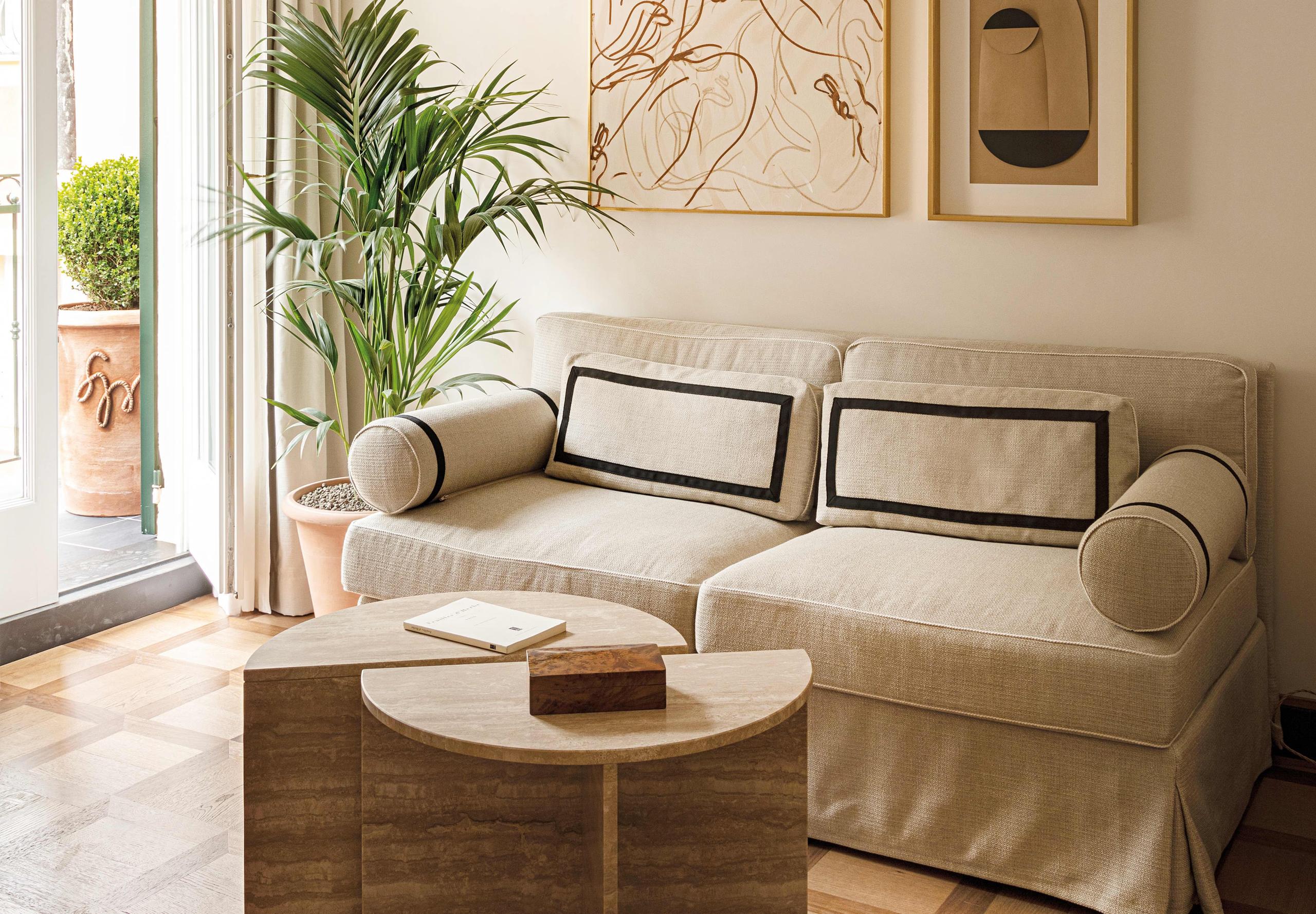 Sitting area with pale green sofa and botanical prints